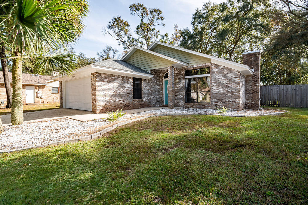 Conveniently located with quick access to NAS Pensacola, Corry Field and Saufley Field, this charming 2 story home offers gorgeous epoxy floors and a spacious living area with vaulted ceilings allowing for a very spacious feel. You'll also enjoy the large shaded back yard with a privacy fence that abuts a green belt easement. This home is a 5 minute walk to the Southwest Escambia Greenway/Boardwalk and 1 mile to South Fairfield Park with access to Bayou Grande. The kitchen comes equipped with granite countertops, built-in microwave, fridge with ice and water dispenser, electric cooktop and pantry with a breakfast bar. The primary suite is located on the first floor and offers a spacious bathroom with a double vanity, garden tub and walk-in closet. Also on the first floor is the laundry room just off the primary suite (washer and dryer convey) which has storage and an additional storage closet under the stairwell. You'll find a convenient renovated powder room on the first floor as well. The second floor has 2 bedrooms and second bathroom with a linen closet and a shower/tub combo. There's also a small bonus space at the top of the stairs that would be great for a small desk, Peloton or make a great reading nook. Other notables are keyless entry, pull down attic stairs for storage, modern electric fireplace in the living room, updated ceiling fans in all bedrooms and French doors that open to the lanai. Check out our full video tour on the MLS and YouTube.