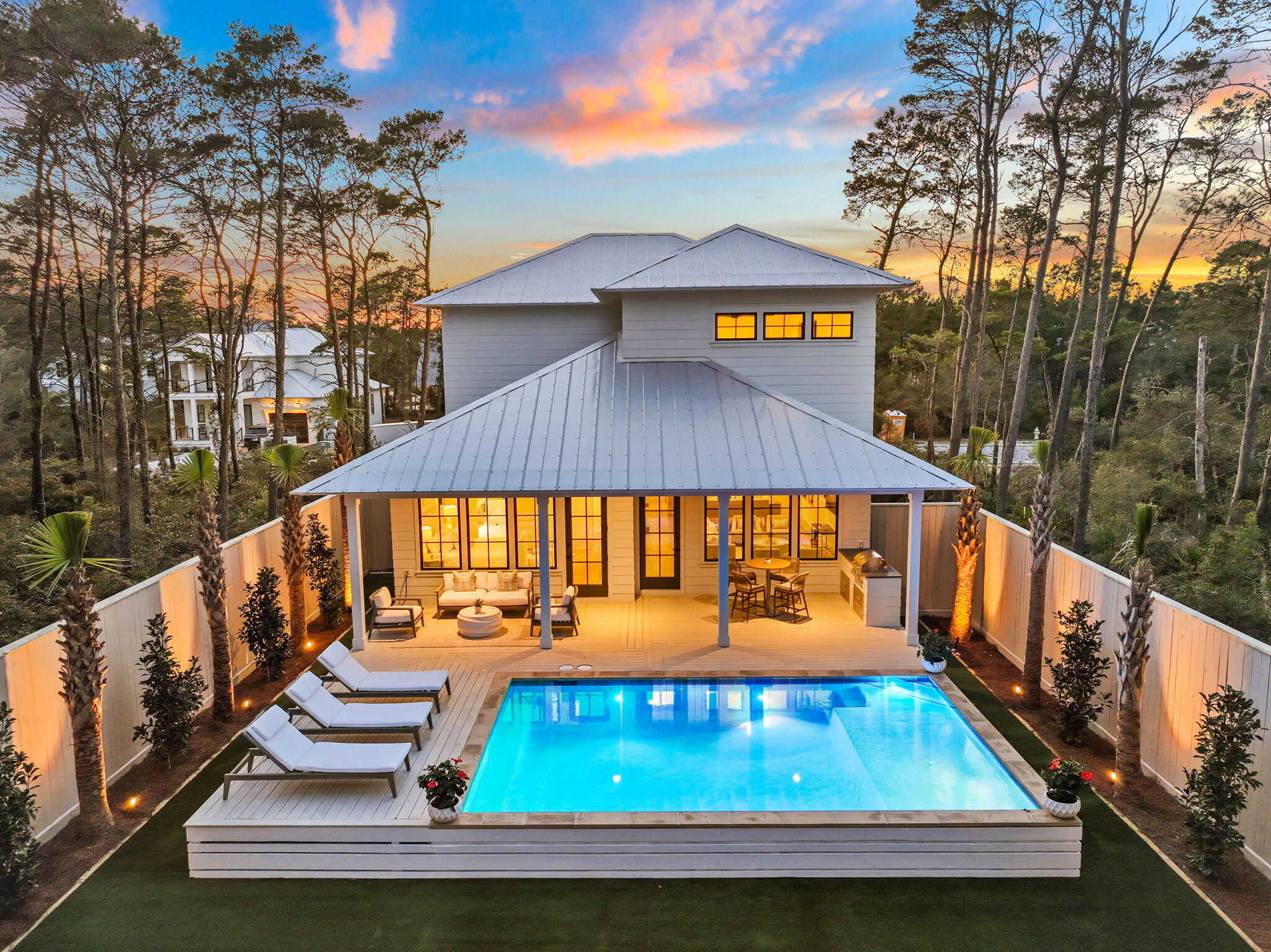 Welcome to your slice of paradise in the prestigious Lakeside community of Inlet Beach, where luxury meets coastal charm. This stunning home, professionally decorated by the talented interior design team at Oak & Anchor and newly constructed by the distinguished team at Focus Construction, boasts an array of upscale features and thoughtful touches throughout.

Step inside to discover a seamless blend of elegance and comfort, where expansive ceilings in the main living area create a grand sense of space and airiness. Cypress wood accent ceilings and hardwood floors further enhance the ambiance, offering warmth and sophistication. The gourmet kitchen is a chef's delight, equipped with top-of-the-line KitchenAid appliances, custom cabinets, and sleek black accent hardware. Entertaining is effortless with the addition of a convenient outdoor kitchen, outfitted with a BBQ grill for al fresco dining and gatherings under the stars.

Step outside into your own private oasis, where the beautifully landscaped backyard is illuminated by enchanting landscape lighting, creating a magical ambiance for evening gatherings or quiet moments of relaxation. Additionally, gas lanterns adorn the front of the home, exuding classic elegance and charm. Privacy is paramount with a fenced backyard featuring turf and lawn games, providing an ideal setting for relaxation.

Venture upstairs to find a second-floor bonus living space, perfect for relaxation or entertainment. This versatile area is outfitted with a wet bar, providing a convenient spot for mixing cocktails or serving refreshments to guests. Residents of Lakeside enjoy exclusive community lake access to the stunning coastal dune lake, Lake Powell. Whether it's fishing, kayaking, or simply enjoying the serene natural surroundings, Lake Powell offers endless opportunities for outdoor recreation and relaxation.

Proximity to 30A Avenue ensures easy access to renowned dining options like Amigos and Amici 30A, Cuvee 30A, Idyll Hounds Proper, The Donut Hole, and Aja Elevated Asian Kitchen, along with shopping destinations. Enjoy the ease of access to the beach and Rosemary Beach through the new pedestrian underpass. For those seeking relaxation and recreation, Lakeside offers an array of amenities including a community pool, all within the confines of a gated community providing peace of mind and security.

Conveniently located near the pristine beaches of 30A and just moments away from shopping, dining, and entertainment options, this is coastal living at its finest. Don't miss your opportunity to experience the Florida lifestyle at 54 Pine Cone Trail. Schedule your private tour today and start living the dream!