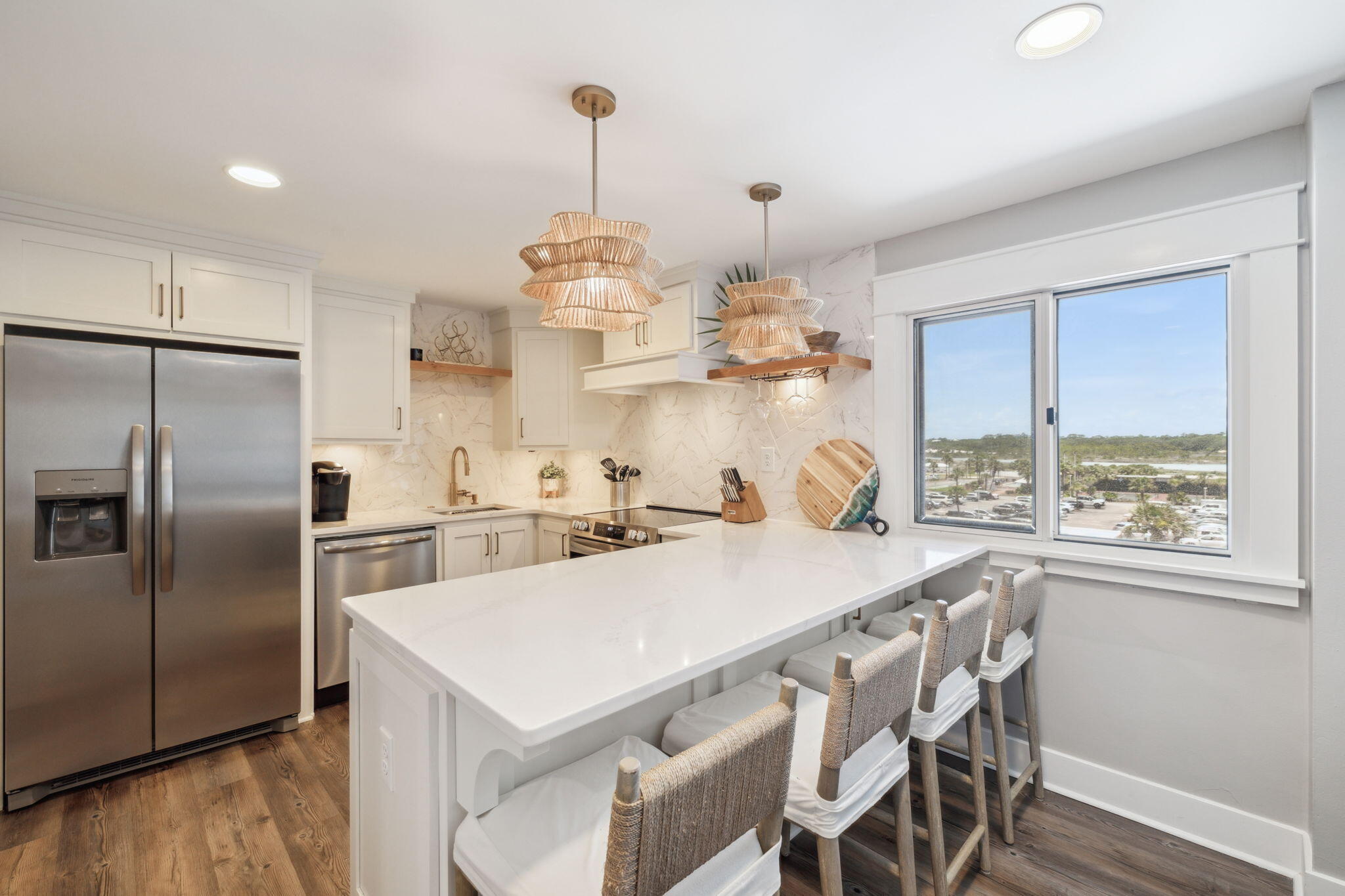 Perched within the gated Gulf-front community of Pinnacle Port, this two-story condo enjoys one of the most unique vantage points on the coast: framed by the Gulf of Mexico on one side and Lake Powell, Florida's largest coastal dune lake, on the other. 

From the moment you step inside, sunlight fills the open, modern interior where water views become part of the backdrop to daily living. An entry closet stocked with beach essentials - chairs, umbrella, and cooler - keeps coastal days effortless. 

The first floor offers an airy open-concept living and dining space with balcony access taking full advantage of the water views of Lake Powell. A dedicated workspace makes it easy to stay connected while embracing the coast. Upstairs, the primary suite offers a queen-size bed, two separate closets, an en-suite bath with a full tub/shower combo, and a private balcony that opens to sweeping Gulf views. The second bedroom comfortably sleeps four with two twin beds plus twin bunk beds and has access to a hallway bath with a walk-in shower. 

Pinnacle Port's resort-style amenities include two swimming pools, four lighted tennis courts, shuffleboard, bocce ball, basketball, a fitness center, grill and picnic areas, and plentiful boating options with a boat ramp, slips, trailer parking, a fishing pier, and kayak access. Just three miles from the boutiques and restaurants of Scenic 30A, close to Publix, and only a short drive to Pier Park, this property combines a rare waterfront setting with convenience and coastal style.
