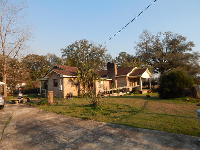 **Buyer did not qualify for loan-BACK ON THE MARKET **Take a look at this investment. There is a lot of square footage and a 5 car garage, at a very affordable price. There is also a possibility that this property could obtain a 2nd home. The survey is showing 2 parcels. One with the home and garages and the 2nd surveyed parcel is a vacant lot that is 100x140. The home needs some updating and remodeling but it appears to be a ''sound'' home with massive potential. It is all brick exterior, has a wood burning stove and a newer 14 seer h/p for heating and cooling.Most of the home is carpeted but much of the flooring is wood underneath the carpets. This property is located on a nice corner lot and has easy access to highway 90 and I-10 exit, is one mile away. Take a look at this home!