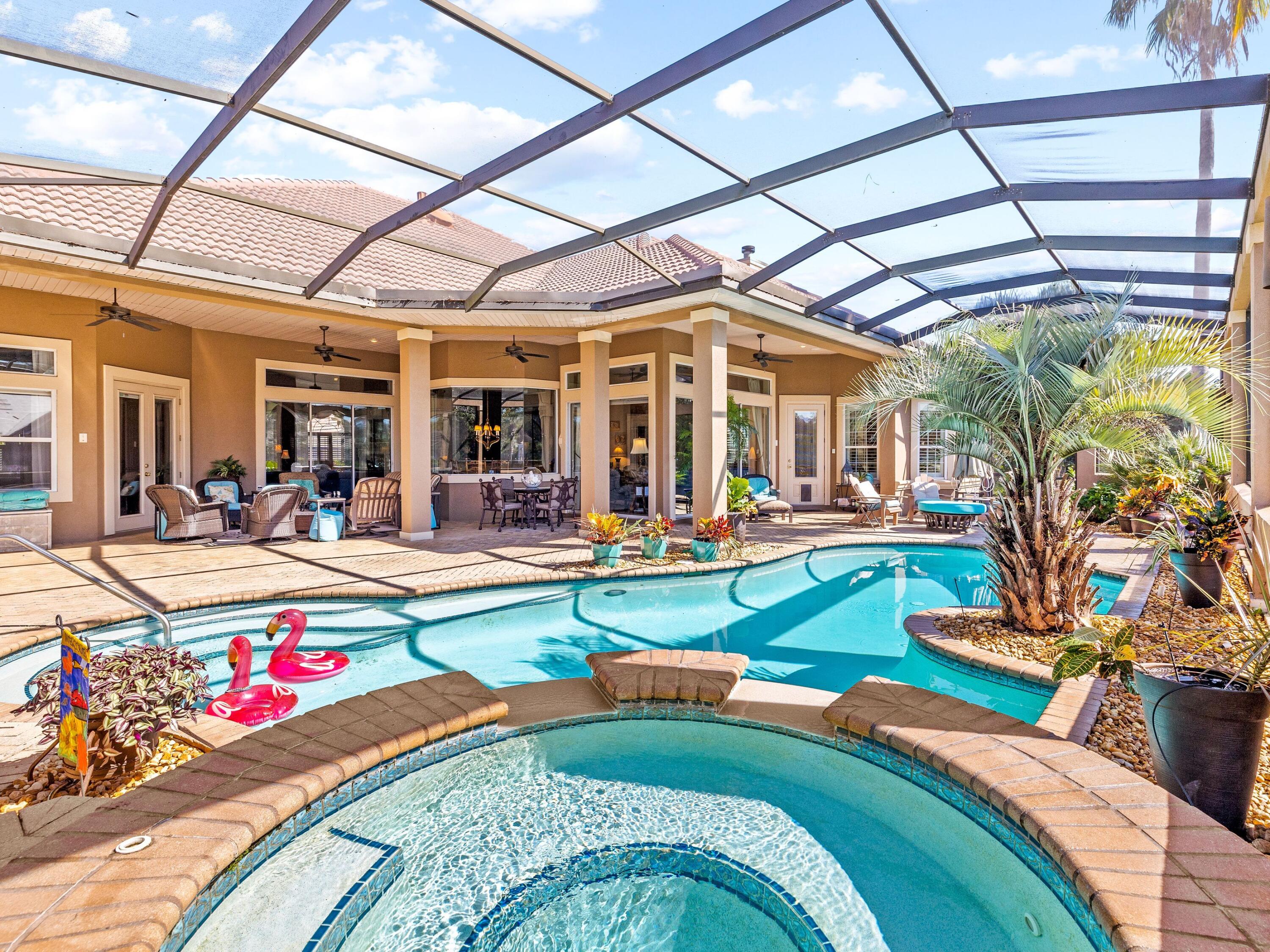 This custom lakefront property with an expansive screened pool area is perfect for embracing the Florida lifestyle. Views from the attractive outdoor sitting area extend across the lake and the Choctawhatchee Bay is right across the street. This sophisticated, single-story home is both spacious and welcoming, starting with the natural landscaped surroundings. A three-car garage completes one side of the L-shaped footprint and the covered porch provides a grand entrance. The light-filled living, dining and family rooms are separate yet seamlessly connected through open arches. Cozy gas fireplaces add a focal point to each beautifully designed space. Head into the gourmet kitchen, which boasts a full range of bespoke wood cabinets around a central island. Granite countertops and a tile backsplash enhance this well-planned space. The cool tile flooring gives way to soft carpet underfoot in the bedrooms and family room. Three beautiful bedrooms and an office make this Regatta Bay home ideal as a primary residence or second home. The master suite is particularly spacious with a sitting area, garden tub, separate vanities, oversized walk-in shower and direct access to the pool. The rear paved patio overlooks the lagoon-shaped pool and bubbling spa. Views extend to mature trees and a serene lake, providing a private, tranquil setting. The spacious covered terrace and built-in summer kitchen make barbecues and entertaining easy when family and friends drop by. Set in an upscale gated neighborhood close to Choctawhatchee Bay, community amenities are second to none. Tennis and pickleball courts are complemented by an Olympic-sized community pool, kiddie park and walking trails. The golf course is one of the best in Florida and you're just a golf cart ride from top-notch dining, Destin Commons, Whole Foods and the Gulf of Mexico.