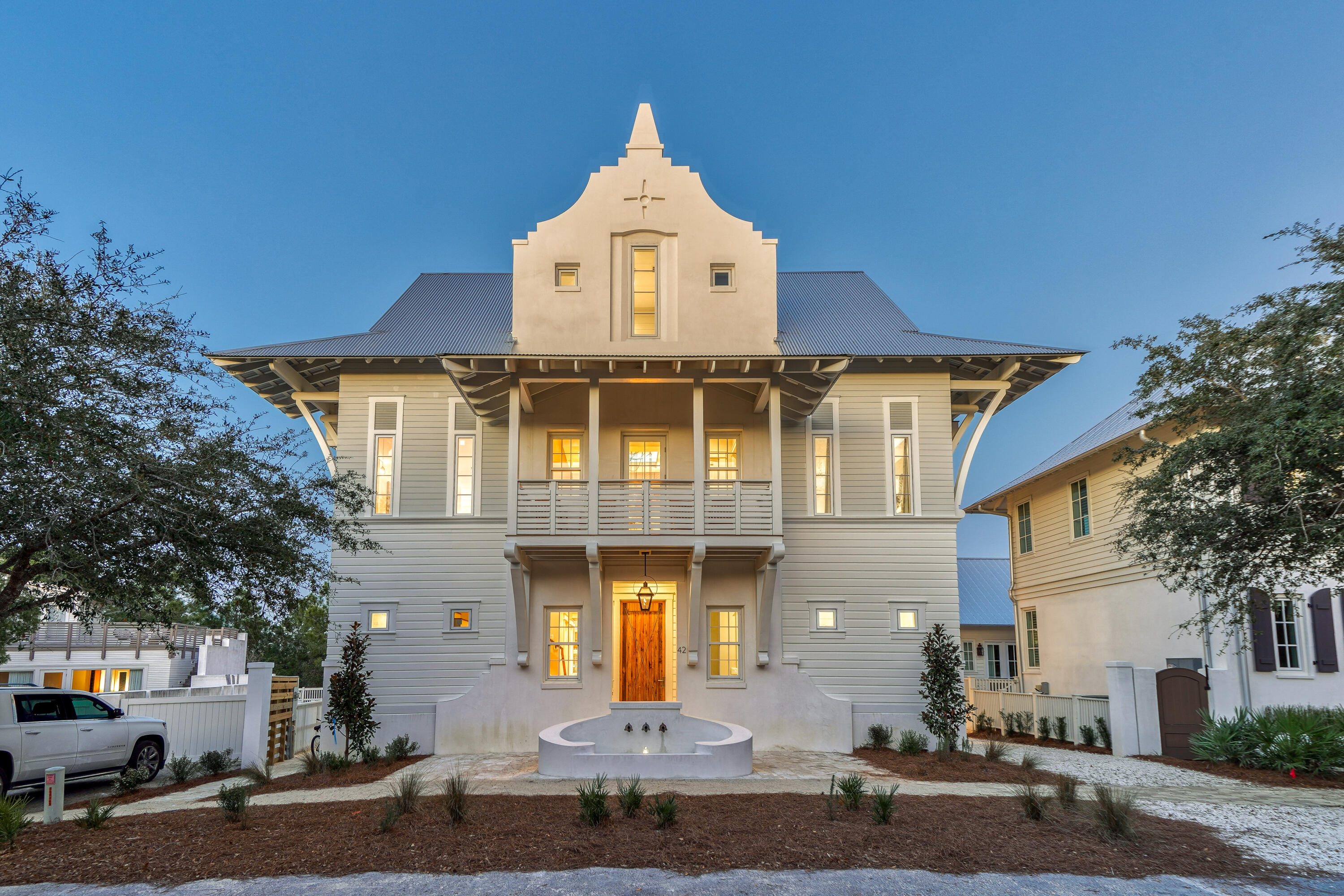 *UNDER CONTRACT WITH A 72 HOUR KICKOUT CLAUSE* 

TAKING BACKUP OFFERS

42 West Kingston Road: A Rosemary Beach Masterpiece

This exquisite 6,300-square-foot custom home redefines luxury living in Rosemary Beach. From the moment you arrive, the meticulous attention to detail is evident. A covered entry porch with a cascading water fountain welcomes you, leading to a handcrafted front door and into a breathtaking double-height foyer. Grand Living Spaces

The foyer sets the stage for the home's grandeur, featuring a custom-designed two-story chandelier, raw steel handrails, and a floating live-edge wood staircase. An elevator provides convenient access to all three levels.

The open-concept living area seamlessly connects the kitchen, dining room, and living room, creating an expansive and light-filled space. Soaring 12-foot ceilings and floor-to-ceiling windows enhance the sense of spaciousness and offer captivating views of the pool courtyard.

Culinary Delights and Private Retreats

The gourmet kitchen is a chef's dream, boasting custom cabinetry, high-end appliances, and a large island that extends into the dining room. A full bar, floating ceiling with a custom chandelier, and arched openings complete the dining experience.

The first-floor master suite is a haven of tranquility, featuring a beamed ceiling, fireplace, dual closets, and a luxurious spa bathroom with a large shower, Jacuzzi tub, and oversized vanity.

Outdoor Oasis and Upper-Level Luxury

Step outside to the courtyard and discover a private oasis. A saltwater pool with a swim-up bar, waterfall, and spa jets invites relaxation, while a covered outdoor living area with a summer kitchen, full bar, and fireplace provides the perfect setting for entertaining.

The second floor hosts three master suites and an oversized bunk room, each with an en-suite bathroom, large closets, and private balconies. A spacious den overlooks the grand foyer.

The third floor boasts another lavish master suite with a sitting area, wet bar, and private balcony, plus a bunk room with an attached bath. A crow's nest balcony offers rooftop views.

Unique Carriage House

A separate carriage house provides additional living space with a vaulted ceiling living room, fireplace, kitchen, two bedrooms, and two bathrooms. This private annex is perfect for guests or extended family.

Additional Features

Single-car garage
Large motor court
Private driveway
42 West Kingston Road is more than just a home; it's an experience. With its unparalleled craftsmanship, luxurious amenities, and prime location, this Rosemary Beach compound offers the ultimate coastal retreat.