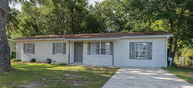Painted Brick Front Three Bedroom Home has undergone a beautiful transformation. Enter the front door to a living room with vinyl planking flooring and find a family room with a charming fireplace on the right. Eat-In Kitchen has gorgeous granite counters, contemporary back splash, stainless appliances and new cabinets. Brand new showers and vanities in both baths. New HVAC August 2019.
Knock down ceilings throughout. Back door from kitchen leads to Large fenced back yard with room for a pool. Perfect location near Hurlburt Field, shopping and a short drive to the white sandy beaches and Emerald Green water of Okaloosa Island and Gulf of Mexico.