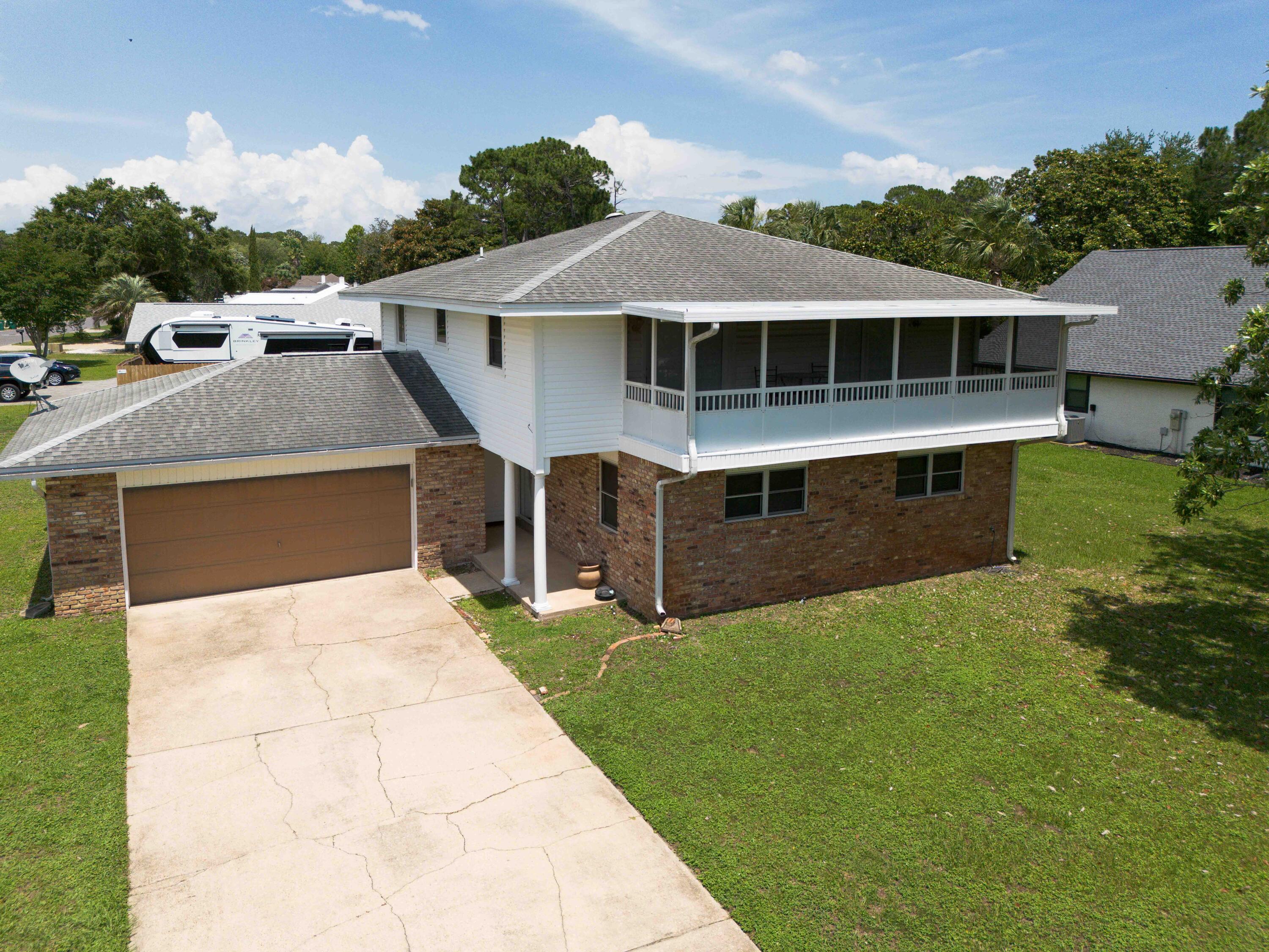 New Price! Plus $20,000 Seller Credit for buyer closing costs, rate buydown, property improvements, etc. Welcome to Raintree Estates! Beautiful remodeled home on a large corner lot with bay views. Major remodel in 2021 included full kitchen makeover (cabinets, gorgeous granite, 9' bar, beverage fridge, SS Frigidaire Gallery appliances., etc.), smooth ceilings, canned lights, primary bath with walk -in shower, custom tile, dble vanities, LVP throughout, etc. HVAC - 2024, Water Heater 2020. Two bedrooms upstairs have french doors out to the 26' screened balcony with amazing water views. Step out back to the large sun porch and spacious backyard! With voluntary membership in the HOA ($150 per year) enjoy the 1.9 acre Raintree Park just one block away!  This is a home you won't want to miss