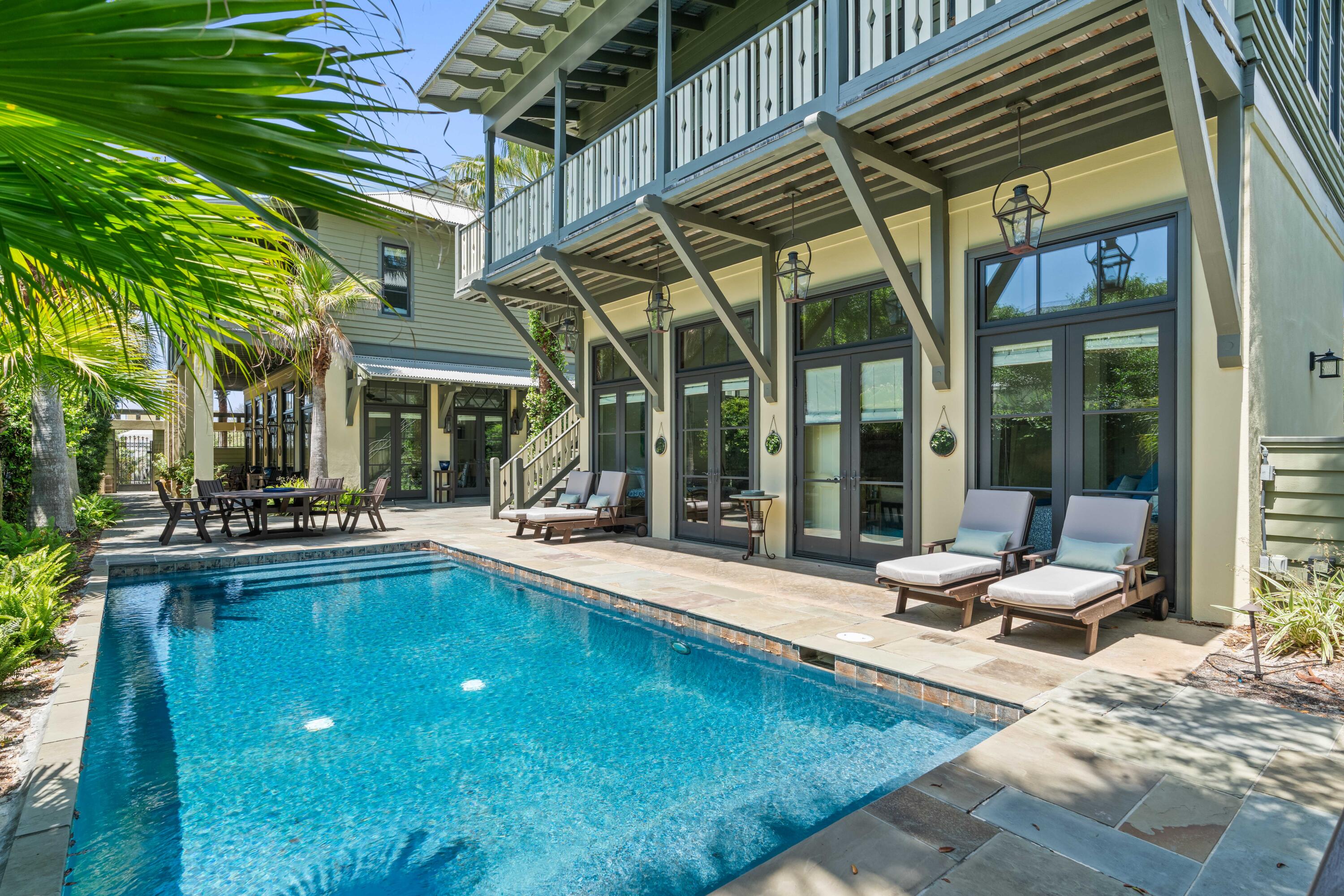 Welcome to iconic Grayton Beach!  Grayton Beach consistently ranks among the most beautiful and pristine beaches in the United States and with this beautiful New Orleans French quarter influenced property you are a very short walk to the white sandy beaches and emerald waters of the Gulf of Mexico!! Enter this beautiful beach abode through a charming wrought iron gate and your personal beach oasis awaits.  The home offers a breathtaking courtyard lined with mature palm trees and ferns and confederate jasimine which just happens to be in bloom right now and its sweet scent fills the courtyard air!  The spotlight of the courtyard is the stunning large heated salt water pool and slate patio. The main house is finished with antique heart-pine floors, custom cabinetry, granite and travertine countertops, alabaster sinks, Dacor double gas range with custom hood, Spanish Cedar French doors lined with transom windows with beautiful wood work accents and soaring 12 foot ceilings where no details were overlooked!  The home floods with natural light and is bright and welcoming! The kitchen has a large island, cabinet fronted dishwasher and refrigerator, a dream of a pantry with a wine cabinet, plenty of storage and a conveniently located washer and dryer and currently has both a seating and dining area and the actually living area also located on the first floor is another large space perfect for hanging with the family or entertaining guests .  A practical half bath completes the first floor.  The second floor offers two bedrooms with a jack and Jill bath and the master bedroom!  The master is large and grand and has a large walk in closet with built in shelving and drawers and a master bath where you can soak in the bathtub while taking in views of Grayton Beach! Step out onto the second level wrap around porch to listen to the sound of the gulf and take a deep breath and smell the salt air!  But wait there is more!  A stately pool house with a bedroom, full bath, kitchen, living area and a second washer and dryer!  Above the pool house there is a second level studio with it own separate entrance with a porch overlooking the beautiful courtyard and pool.  It again has a bedroom, wet bar, full bath and is spacious!  This property has charm and character and feels like home the minute you enter, not a detail was overlooked!  This Grayton Beach home surely won't last long!  Call to schedule a showing today!