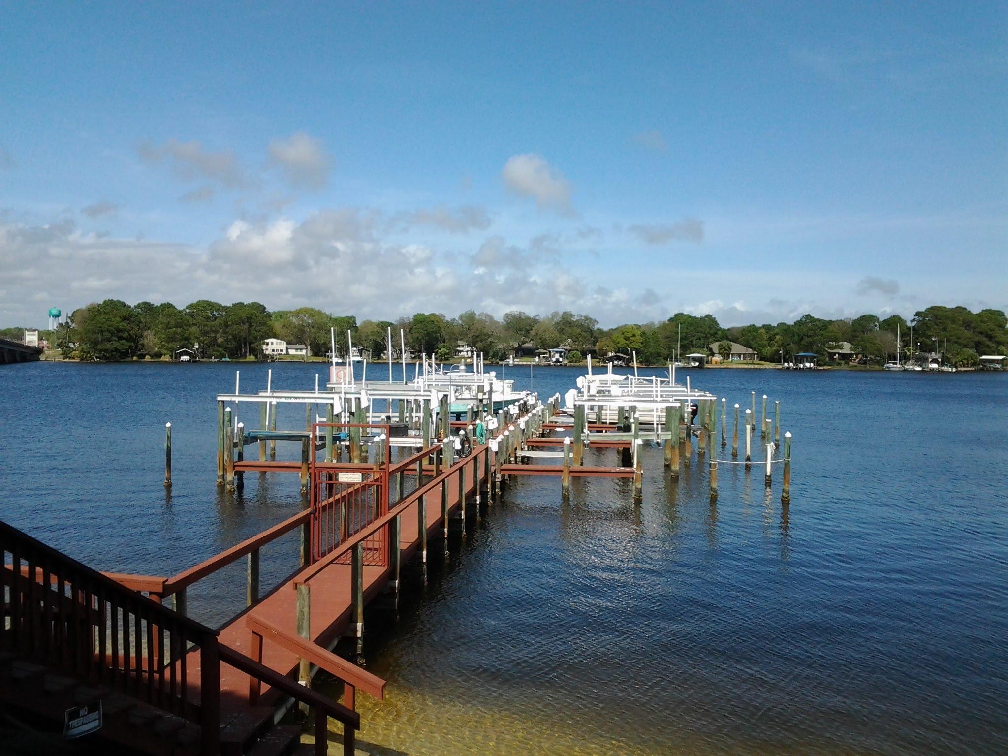 Waterfront and Water view! Now is your chance to own a 3 bedroom/ 3 full bath ground level end unit at Laguna Landing. Gorgeous views of Cinco Bayou and boat slip number 4, 12000 lb. boat lift conveys. Covered parking # 6 and exterior storage convey. KItchen has gorgeous solid surface counters, new cabinets, Stainless Appliances and NEW AC installed 09/19. Water views from every room except one bedroom. Exit through sliding doors toward boat dock and slip number 4 just steps away. Request to see video if you prefer to not view unit in person. Water accessible from side of unit with gate for yard for small pet. Cinco Bayou leads to Choctawhatchee Bay, Crab Island and Gulf of Mexico. Swimming pool and community room. Resort living at home! VA approved and no short term rentals.
