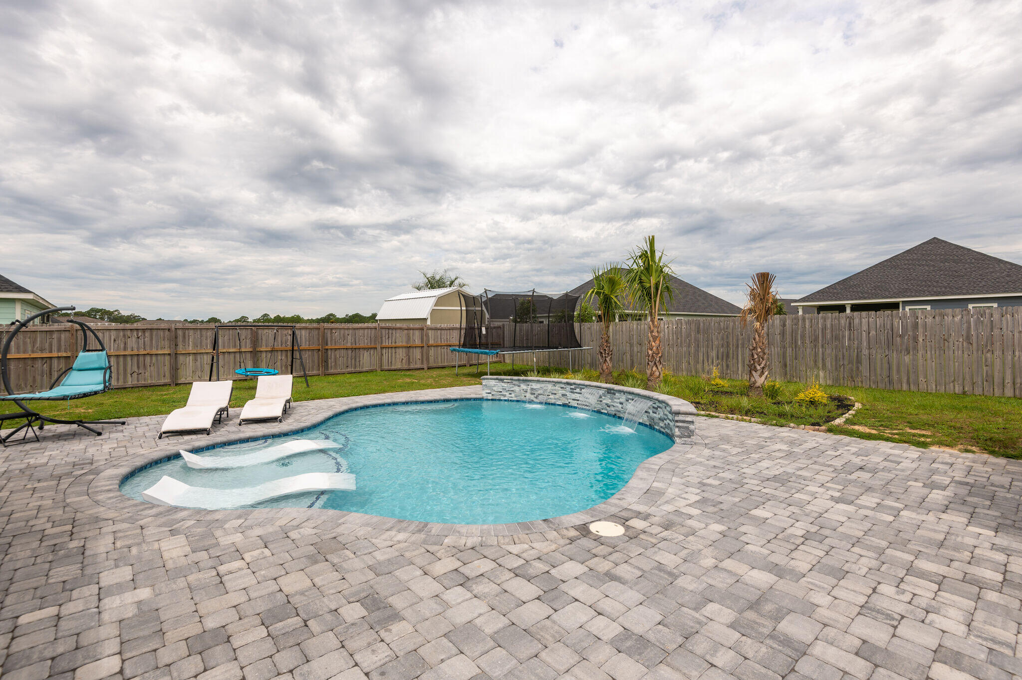 WELCOME TO YOUR PRIVATE POOL HOME.  Your Family Will Always Feel Like They Are On Vacation In This Beautiful Pool Home.  Featuring Updated Colors Inside And Out, LVP Floors Throughout The Home, XL Master Bedroom As Well As XL Master Bath With Soaker Tub And Custom Walkin Closet Organization, High Ceilings, Granite Countertops, Covered Back Porch, Outside Storage Bldg And Once Again Your Own Private Pool With Fountains. You Are Outside Of The Hustle And Bustle Yet Just A Short Drive To The Sugar Sand Beaches Of 30A.  For A Family, This Is Located By Excellent Schools, Just Outside Of The Subdivision.  Just Minutes Away From The Oar House And Oyster Bar Rest At The Marina On East Bay Loop As Well As The Wonderful Restaurants At The 331 Bridge.  And Convenient to I10. Life Is Good In This Hom Buyers To Verify Any And All Info
