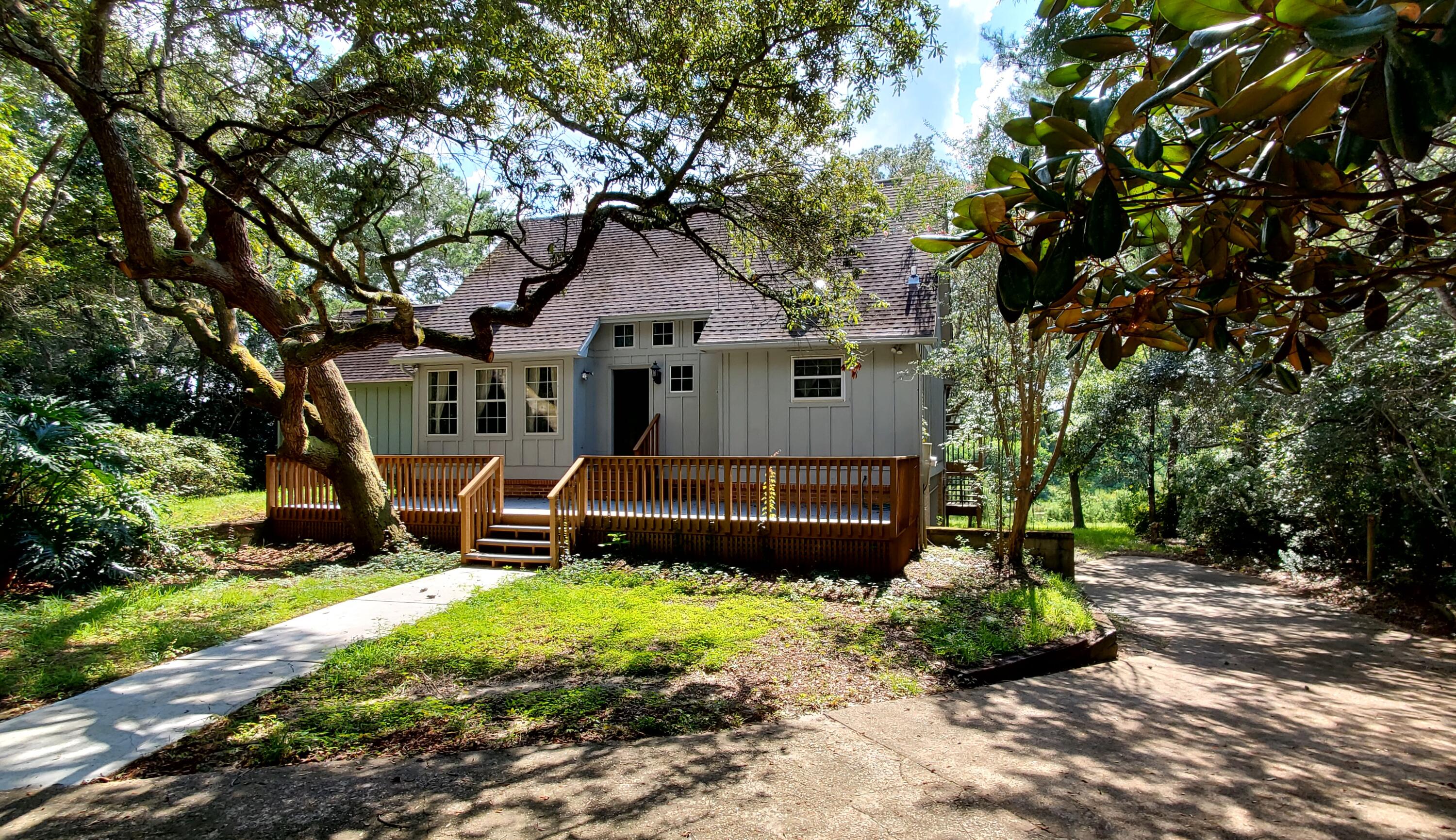 Lakefront and golf course view home on private 3/4 acre lot in Bluewater Bay. Featuring  vaulted ceilings, authentic wood ceiling beam accents and lots of potential. New composite wood deck on front deck and back balcony. The main floor offers the living room, updated kitchen, master bedroom with enclosed balcony/sunroom and master bath, dining room along with additional half bath and den/study with recessed bar and balcony. This could potentially be converted into a forth bedroom. The second floor has two nice sized bedrooms separated by a loft area and full bath. Off the lake side of this home is a large finished basement assessable and on the same level as the backyard with a screened and covered sunroom. Another potential bedroom, art studio or guest quarters? The two-car garage comes . Another potential bedroom, art studio or guest quarters? The two-car garage comes with two workspaces. One located at the front of the garage and the other towards the back of the garage. Great place for workshop and or golf cart parking. Let your imagination run free and come checkout the location and great possibilities this home has to offer. Home sold as is.