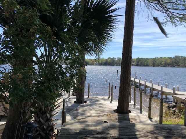 Showings begin with an OPEN HOUSE on Sunday, March 27 from 1:00 - 3:00 p.m. Make your dream come true! This is the home you've been waiting for. Come see this beautiful waterfront townhome in the much sought after community of Water Oaks. The home has been freshly updated with new luxury vinyl plank flooring throughout the main floor and new carpet upstairs.  Fresh paint throughout, beautiful quartz countertops appropriately named ''white sparkly'', new subway tile backsplash and stainless appliances are just a few of the renovations (please see supplemental document sheet listing all pertinent information.) Enjoy sweeping views of the Boggy Bayou from both the living area and your master suite.  Beautifully situated among mature oak, magnolia and cypress trees the property also has flowering azaleas and other blooming plants that frame the path to your 88' dock. The dock was completely rebuilt in 2021 using "ThruFlow Premium" decking, wrapped pilings to prevent rot, new end caps and ropes, water and electricity.  Installation of a boat lift can be applied for with the community architectural review committee for their consideration. Water depth at  mid-dock is typically 6+ feet and around 8' at low tide from the end of the dock. The present owners had a 30' sailboat and the dock, which is shared with unit 606 (each owner has one side) will accommodate much larger boats.  There is also a piling for anchoring large or extra vessels with a depth of 15+ feet. Enjoy panoramic views of protected deep-water Boggy Bayou and phenomenal sunsets from your large waterfront deck.  You'll have front row seats for the annual Niceville fireworks show on the 4th of July! Don't miss this RARE opportunity to own waterfront with beautiful views in a protected deep water location. Flood insurance is not required. Short term rentals are not allowed in this complex. Showings begin with an open house on Sunday, March 27 from 1:00-3:00 p.m.