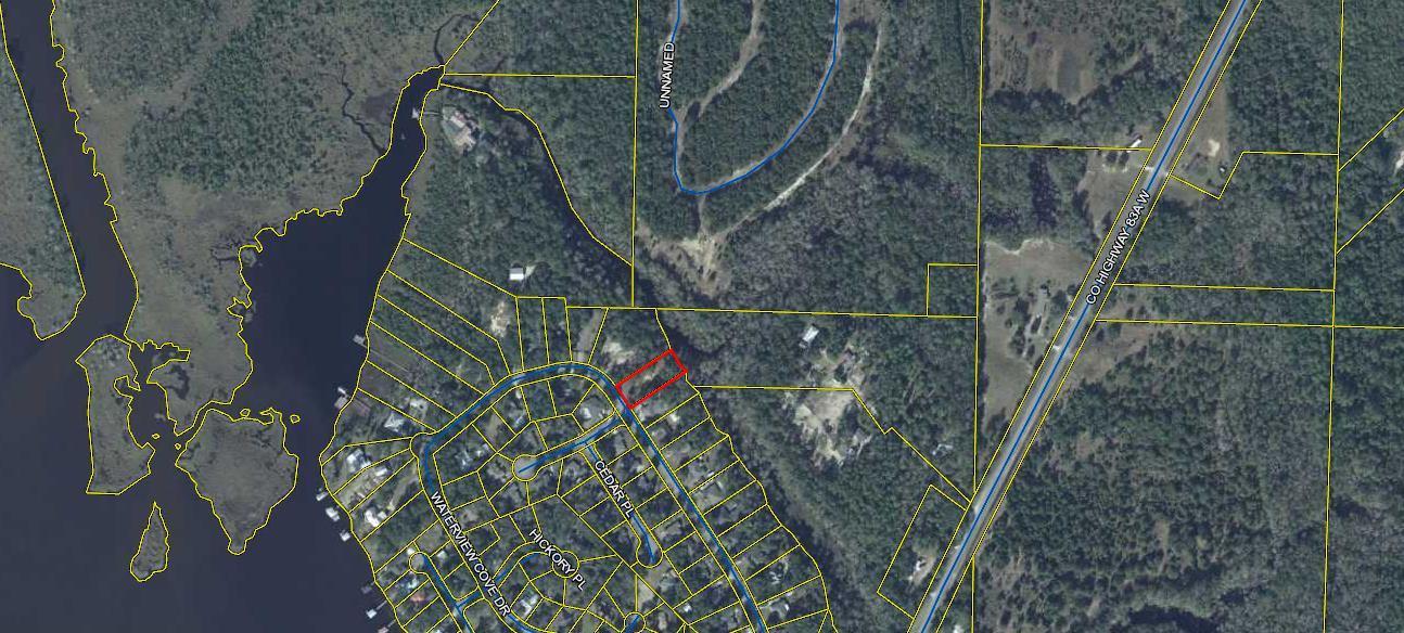 WATER & SEWER TAPS + IMPACT FEES ALREADY PAID SAVING YOU THOUSANDS OF $$$ !!! Opportunity Is Knocking For Your Own Waterfront Lot In Freeport. Towering Hardwood Shade Trees Remain After Lot Was Partially Cleared Leaving Beautiful Home Site. The Neighborhood Has Recorded Covenants & Restrictions. No Active HOA, No HOA Fees, No Build Out Time. Nice Assortment Of Home Styles Throughout Community. There Is A Community Boat Ramp In The Neighborhood Or Launch Your Kayak/Paddle Board From Your Back Yard. Buy This Lot To Build A Home Or Hold For Investment. Freeport Is Growing With Publix, Ace Hardware, Waffle House, Taco Bell..... Opening New Locations. Hurry Up And Buy This Lot Before This Opportunity Passes.  Hurry & Call Today To Make This Lot Yours!