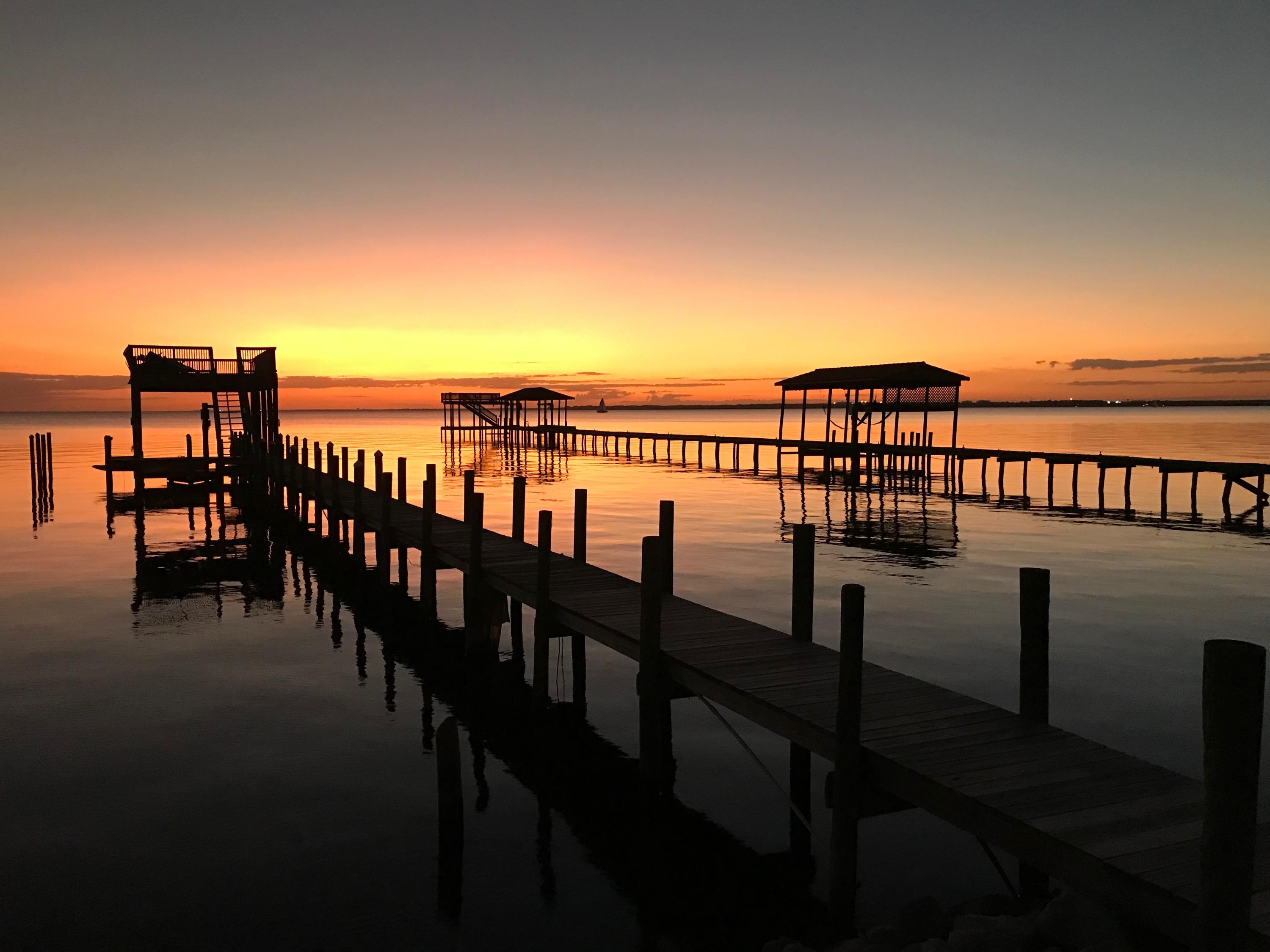 HUGE PRICE REDUCTION !!! TAKE A LOOK AT THE LAST WATERFRONT LOT AVAILABLE IN SUNSET BEACH PRIVATE COMMUNITY.
LOT ALREADY HAS A DOCK WITH A COVERED BOAT SLIP AND RAISED SUNDECK FOR ENTERTAINING AND THE MOST SPECTACULAR SUNSET VIEWS. SUNSET BEACH IS ONE OF 2 GATED NEIGHBORHOOD'S ON THE WATER IN BLUEWATER BAY. PRIVATE CLUB HOUSE AND POOL IS ALL PART OF THE HOMEOWNERS ASSOCIATION.