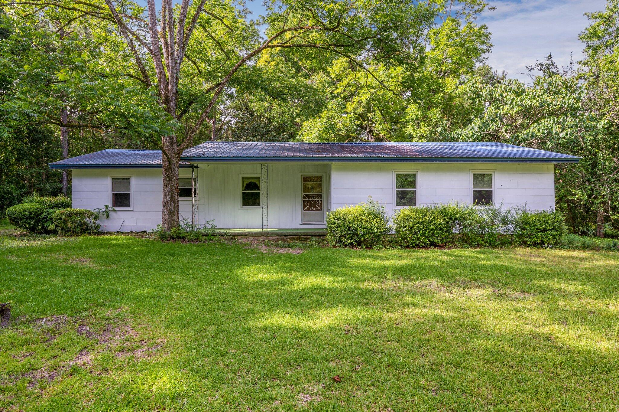 SAME LISTING AS VACANT LAND MLS# 901751 ATTENTION INVESTORS:  Unique opportunity with many development possibilities. This property is ideally situated inside city limits in one of the FASTEST GROWING counties in the U.S.  The 6.8 acre property is located appx 1.2 miles from I-10 and a mere 30-40 min to the beaches of Walton County. Zoned R2 in Walton County (16 per 1 acre) – ideal for apartments, duplex homes and/or a new home community. City water is available with public sewer in close proximity. All other utilities are in place. The home is estimated to have been built in 1946 and conveys AS IS. Windows were replaced in 2005.  There is a natural pond in the southeast corner of the property – well pump in place.  SELLER will contribute UP TO $5,000 towards the Buyer's Closing Costs