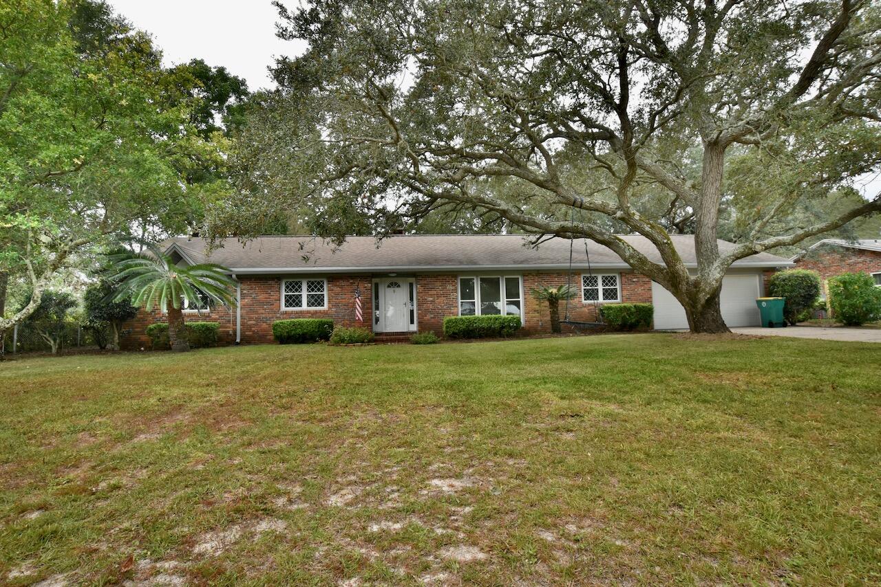 Beautiful home in great established neighborhood. Across the street from the bay. This 4 Bedroom / 2 Bath brick home features all tile flooring. Open kitchen and living area. Large laundry room and spacious bedrooms. The backyard has large covered porch with beautiful trees and view of Shalimar Pointe golf course.