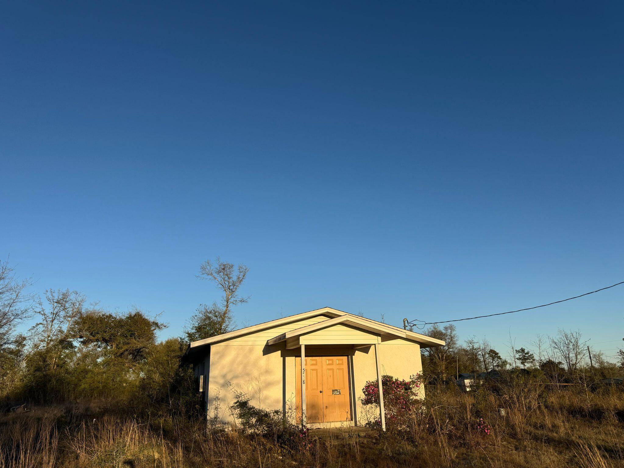 PRIME LOCATION! This 1.43-acre property tucked away in the quiet Bayou George Heights community offers incredible potential in a peaceful setting. Just a short drive to Tyndall Air Force Base and Panama City's shopping, dining, and white-sandy beaches; this property offers both convenience and tranquil surroundings — the perfect combination for investors, builders, or homeowners looking to create something special. Featuring a sturdy block construction with a stucco exterior, a new roof (2019), and updated HVAC, this former church space is ideal for various uses. The county permits the use of this property for duplexes, single-family homes, and mobile homes.