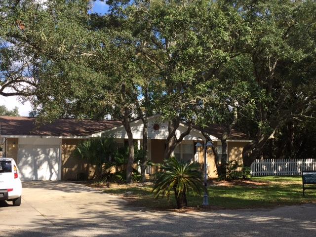 A sharp uptown feel with character and charm is what you'll find in this remodeled unfurnished 3BRD/2.5BA home. It comes equipped with a front porch swing allowing relaxed enjoyment of the sound view. Not to mention there is deeded access to the sound. The open concept living, kitchen, dining, all have beautiful saltillo tile. The screened back porch is accessible from the dining & master bedroom. There is a travertine shower in the master & tub in hall bathroom. The heated and cooled 1 car garage can be used to store items or even transformed into a bonus room since there is ample parking in the drive and to the side of the house for larger vehicles. Off the garage is a back room with a half bath. Imagine the possibilities for an office, crafts area etc. This property is furnished with a convenient non-warranted washer/dryer. 

The picket fenced side yard is small for easy upkeep and comes with a fire pit ready to use. The yard is well shaded from the hot Florida sun and allows you to fully use each space for family enjoyment & entertaining. 
This home is located in one of the most charming, quiet, walk-able neighborhoods in Navarre and is just a few blocks away from Publix. Walk a few lots down to the deeded access & put in your boat or kayak for a day on the water.