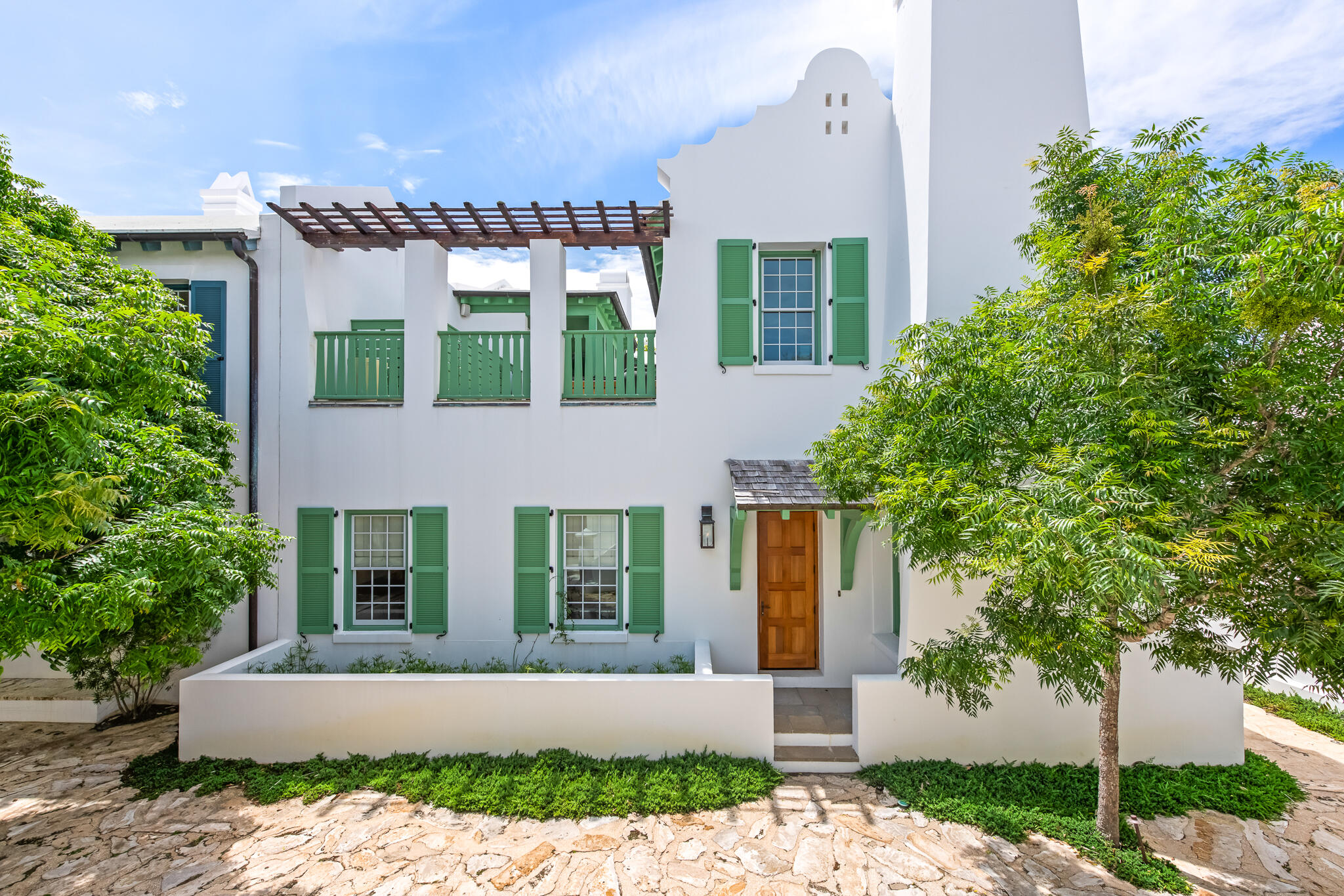 Fronting the Sea Garden Pedestrian Path and Mojito Alley in Alys Beach, this 2,739-square-foot courtyard home delivers strong architectural presence and functional design. The 20-foot vaulted living room ceiling brings in natural light and creates a feeling of openness. Hickory floors and honed granite countertops add warmth and texture to the streamlined interiors. 

A fireplace nook anchors the main living area. French doors from both the living room and first-floor primary suite open directly to the private courtyard. Designed for year-round use, the courtyard includes a dipping pool, built-in seating, and an outdoor fireplace surrounded by mature greenery.

Upstairs, two guest suites connect through a louvered gallery and open onto a spacious rooftop terrace overlooking the landscaped pedestrian pathway.
Balanced architecture, defined spaces, and seamless indoor-outdoor flow make this home a strong courtyard offering.

 Furnishings will accompany the sale of this property. This home is built to "fortified for safer living" standards.