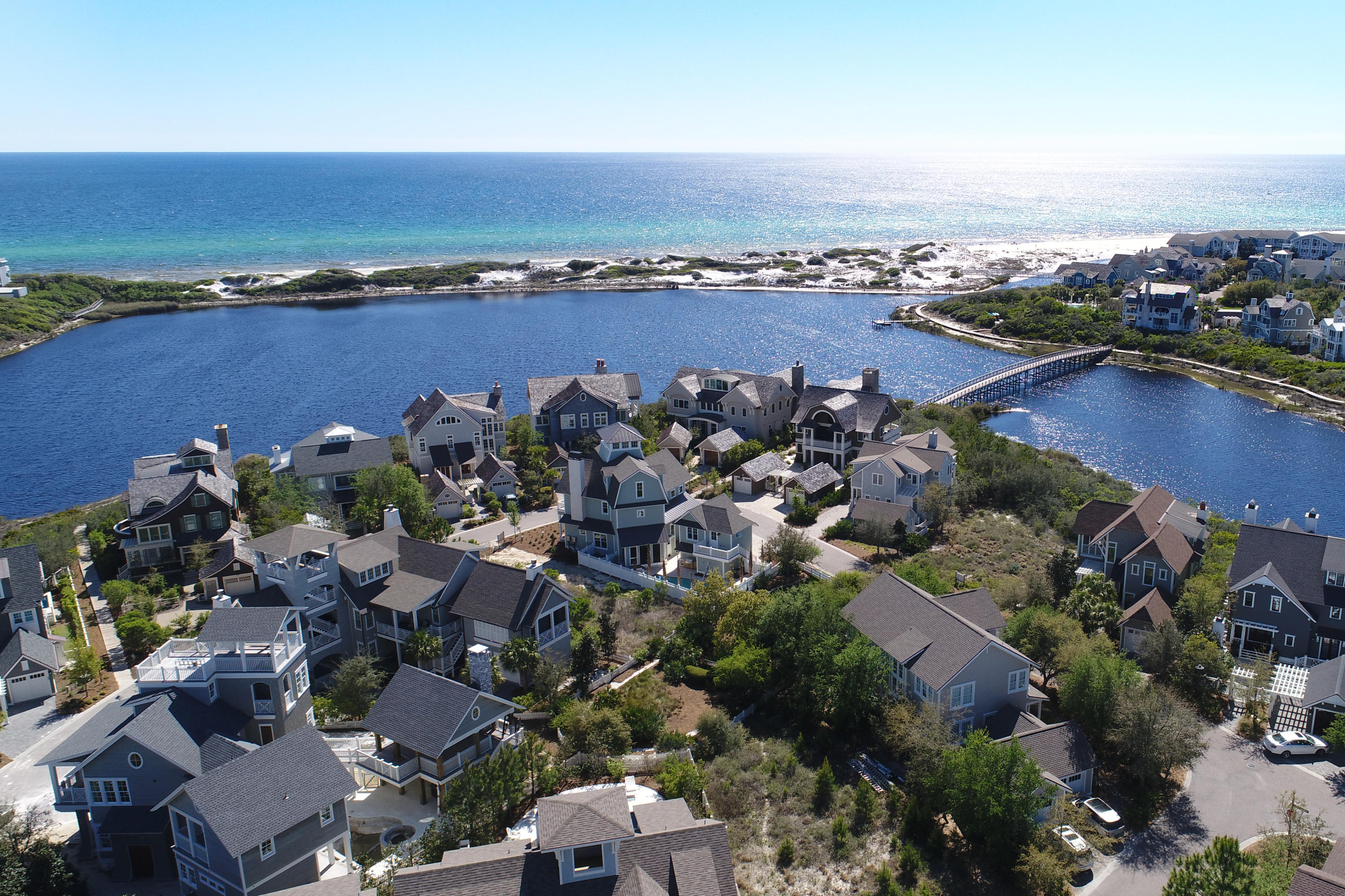 Coastal dune lakes are extremely unique, and this lakefront lot awaits your very own home design in the charming gated-community of WaterSound Beach. This spectacular property and incredible amenities that come with
can be yours. Walk or hop on your bike to enjoy community pools, restaurants, boardwalks, friends, neighbors and enchanting pedestrian bridges that wind over and through the white sand dunes. The security entrance lends a measure of comfort, and this lovely lot sits on a coastal dune lake, ready for your personal style, your stamp of approval, your unique Florida home.