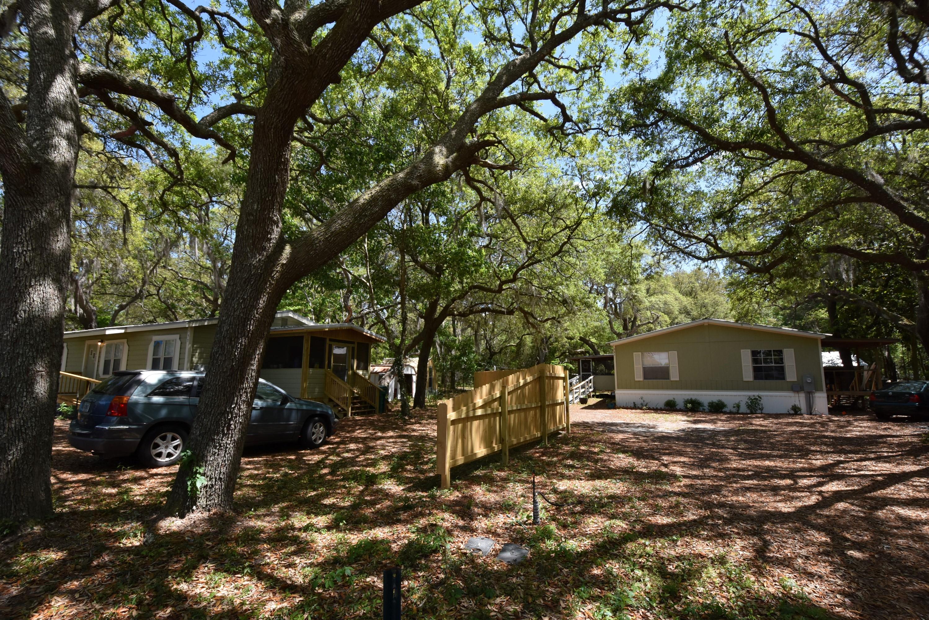 Investors special with 3 Separate dwellings on the 1 ACRE property. 15% RETURN ON INVESTMENT! Located on Bay Loop and just outside of the Hammock Bay entrance on Co Hwy 83A. All THREE dwellings are occupied. #553 is the Cottage with 3 bedrooms, 1 bathroom, septic tank, and private well. #561 MH has 3 bedrooms, 2 bathrooms, septic tank, and public water. #579 MH on the back of the property has 2 bedrooms, 1 bathroom, septic tank, and public water. Current rents are $1,000/$1,200/$700. All dwellings have washer/dryer hook ups. Renovated properties end of 2017 with roofs, well, HVAC, appliances, flooring, and much more! Bike/Walk path along the property's edge runs Bay Loop Road and into Hammock Bay.