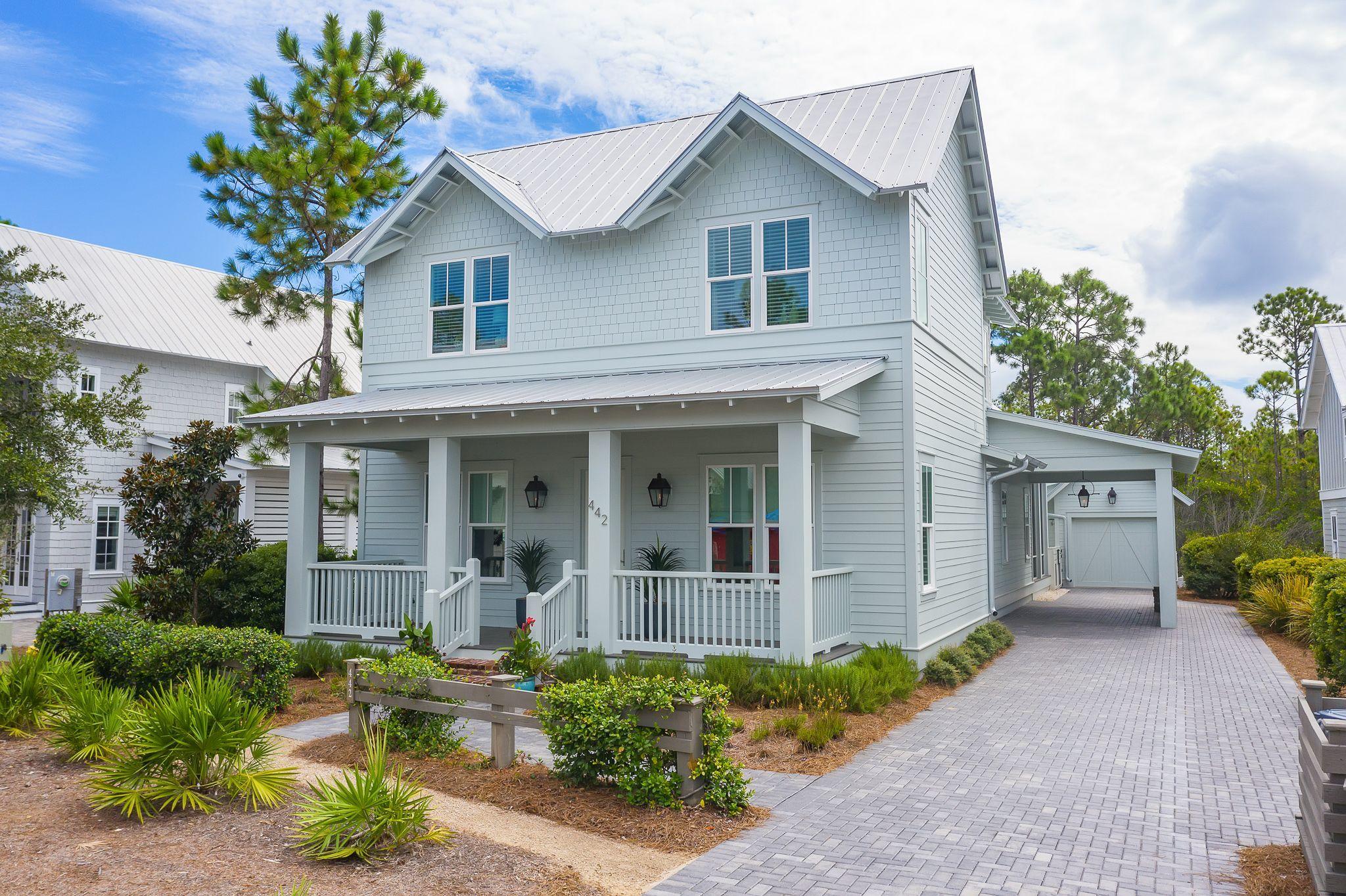 This 5 Bedroom, 4 bath house in phase 4 of Watercolor is beachy elegance at its best! This home offers ample parking on the large paver driveway, a car port, also a one car detached garage, and a large screened in porch that overlooks its own private pool and spa that backs to nature preserve. The entire interior of this home has been freshly painted and the Calcutta Gold marble counter tops have been refinished as well. The kitchen offers an over sized island with seating for 4, wolf and subzero appliances to include a wall oven, gas cook top, custom hood cover, dishwasher and counter to ceiling marble herringbone back splash. The kitchen overlooks the living area with includes a wet bar complete with an ice maker and wine refrigerator.

The kitchen also opens to the dining room with transom windows above the entry way and overlooks the screened porch and pool and offers plenty of windows allowing for an abundance natural light into the home! This home offers the sought after first floor master bedroom. The master bath has double vanities, stand alone shower, garden bath tub and a huge walk in closet. An additional bedroom, full bath and laundry room with storage closet complete the first floor. The second floor is complete with shiplap walls, offers two additional bedrooms each with ensuite baths, a bunk room and a large media room complete with leather movie chair recliners! The WaterColor community includes residential homes and a beach-side resort on the beautiful Gulf of Mexico and the breathtaking coastal dune lake, Western Lake. Quaint streets and pathways connect homes to the community parks, shops, the lake and the beach making biking, running and walking that much more enjoyable! The Watercolor community offers several resort style pools to include water slides and a lazy river, tennis courts, basketball courts, playgrounds, fitness center and a boathouse stocked with kayaks, canoes, paddle boards and fishing equipment. This beautiful home is a must see! Please call to schedule a showing today!