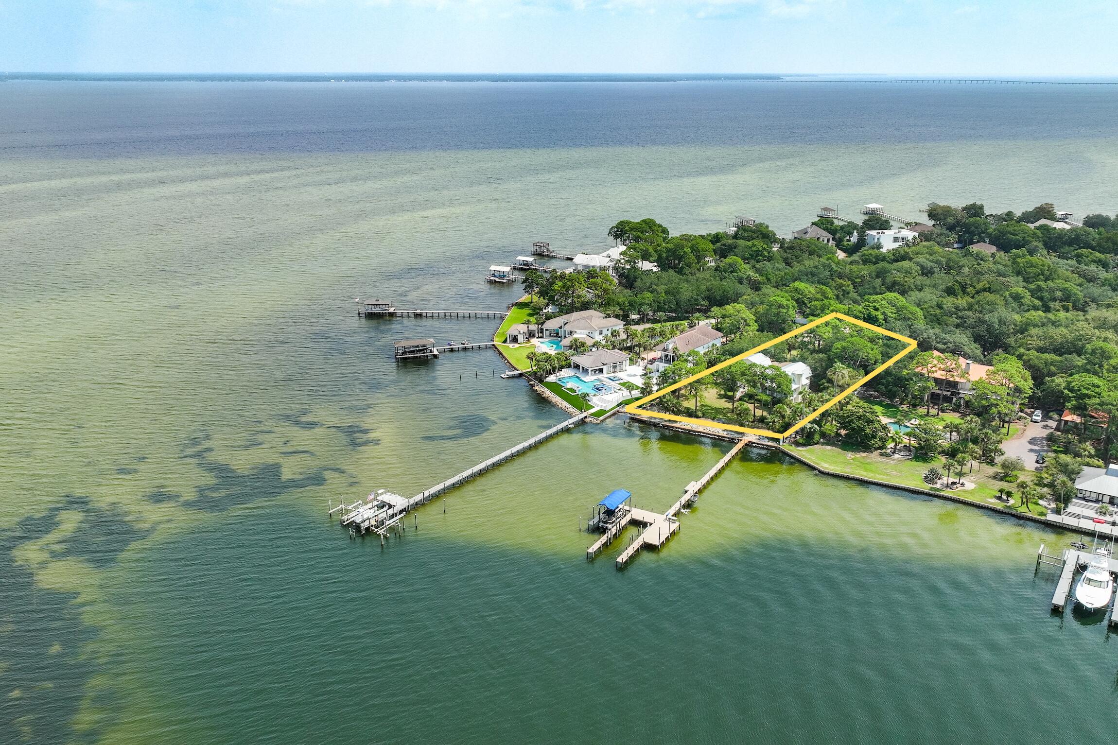 This PRIME property is situated on an estate sized lot and quiet cul-de-sac, with 165 feet of water frontage at the mouth of deepwater Joe's Bayou and Choctawhatchee Bay. A gentle curving driveway leads to an impressive entrance reminiscent of a Key West Home with expansive water view from main living area, including the kitchen and dining room. This home features refinished solid wood floors, granite Kitchen countertops, large wet bar off main living area featuring a Wine Cooler, Ice Maker, & cabinets. Luxurious master bath with travertine, Jacuzzi tub, walk-in shower, outdoor CalderaSpa, Indoor/Outdoor surround sound Sonos System, and 2 car garage. 

One bedroom ground residence. Upgraded Dock to boathouse & slip. DEEP WATER ACCESS & TRULLY MAGNIFICENT SUNSET