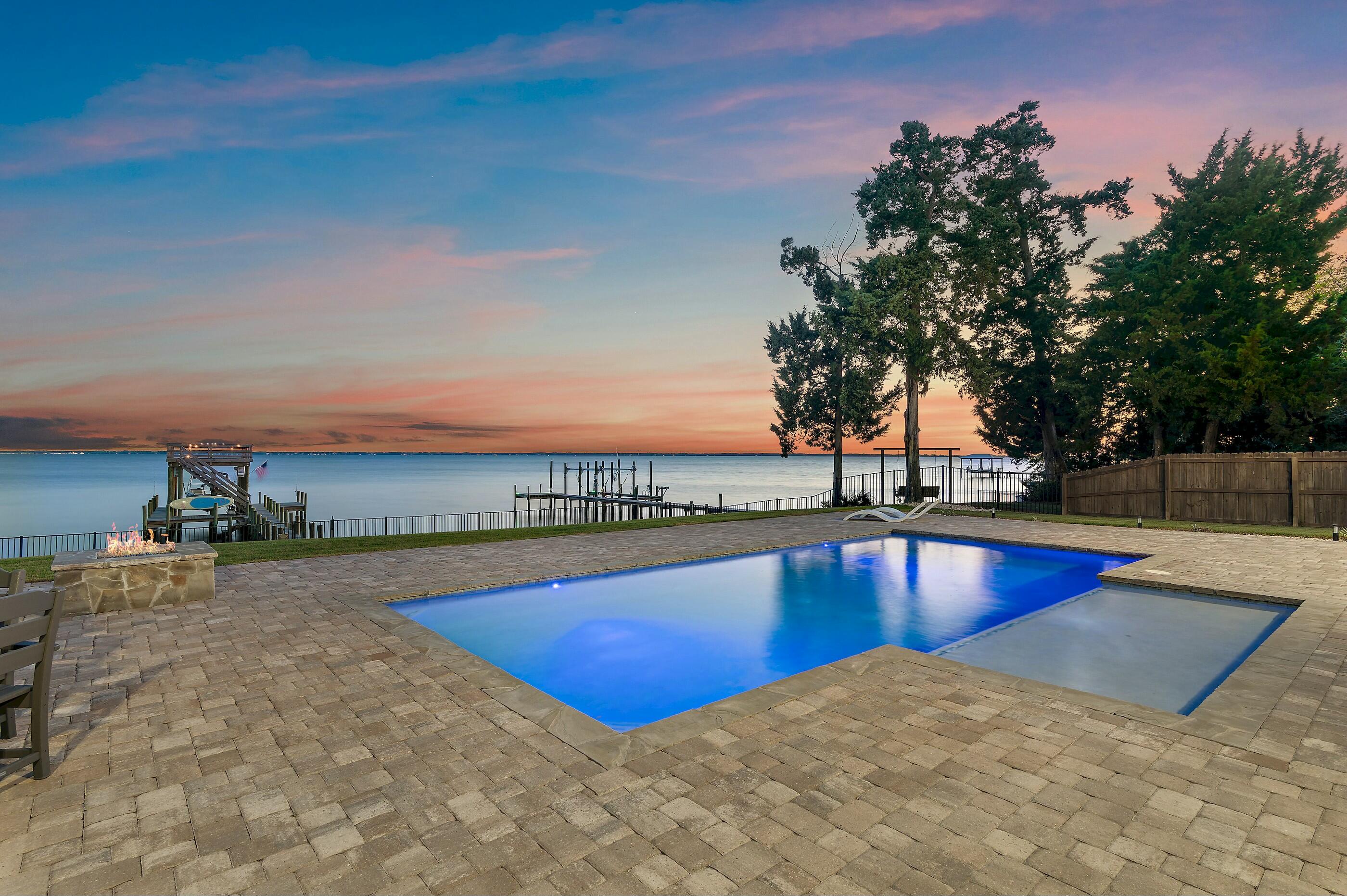 Absolutely Stunning Bayfront Estate featuring immaculate 2022 Coastal Farmhouse construction on coveted Red Barn Road in Flood Zone X. 4 Bed/4.5 Bath with detached garage, pool, yard, dock spanning .66 acres with 100' of Bay frontage. The spacious private drive with ranch style fence welcomes you into the serene beauty of pristine Bayfront living offering tranquility and space to live your best life without the confines of an HOA. Gorgeous front elevation with custom Coastal Farmhouse design greets you with a warm from porch featuring tongue and groove ceilings and a hurricane proof front door that will blow you away with its glamor and stature.  The Southern charm blends Coastal elegance as you enter the home. French Oak hardwood floors span the downstairs open living concept with raised coffered tongue and groove ceilings projecting natural light onto shiplap wall feature from Bayview windows

The kitchen features Calacatta Borghini Quartz countertops throughout with shiplap accented island featuring a farm sink with bronze gooseneck pulldown and disposal. Marble backsplash with recessed lighting, custom cabinetry, gas stove with hood, double oven and stainless steel appliances. Quaint dining area with canned downstairs lighting offers pool and Bay views and access to back porch and grilling area. Convenient half bath with Pottery Barn marble vanity and oversized mudroom with quartz sink with washer and dryer offer direct access to exterior porches. Interior kitchen corner features huge walk-in pantry.

Master Bedroom downstairs offers beautiful Bay views and door to back porch hot tub. Master Bathroom features custom Pottery Barn marble vanity, freestanding tub, large shower area, and Alaskan white herringbone porcelain tile and oversized walk-in closet.

The front of the house features a 2nd downstairs bedroom with bathroom featuring Pottery Barn marble vanity and subway-tiled shower. Work from home with a large office just off the front foyer. Upstairs features 2 bedrooms with Bay views that are on opposite sides of large upstairs living area featuring high-end wall-to-wall carpeting for comfort and an additional room for storage.

Exterior home built to last with 2x6 framed walls, hybrid shingle roof with metal accents, exposed rafter tails on all roof overhangs, and Anderson black on black windows throughout with all exterior doors hurricane rated.. Back porches offer sublime pool/bay views and all painted and sealed with tongue and groove ceilings above that feature a 6 speed fanned sitting area with television, summer kitchen with Blaze gas grille can Cavaliere vent, min-fridge, and outdoor sink. Outdoor shower and Hot Springs Hot tub offer extra convenience and comfort in this sublime oasis.

Step off the porch to a luxuriou 13'x32' pool with 6'x15' tanning ledge all built by Blue Haven pools with light features that change color. Enjoy views from the pool or gas fire pit. Zoysia grass between the Bay and pool is all irrigated using an 8 zone Rain Bird irrigation well and black aluminum fence bordering the seawall and rip-rap along 100' of private frontage along the Bay. A pier leads you from there to the boat dock featuring an 8,000 lbs. remote control Breeze boat lift accommodating up to a 32' boat with water and 220 and120 power. Water is deeper than most areas on the north shore of the Choctawhatchee Bay and allows for a convenient 5-minute boat ride to The Bay, North Beach Social and Farm & Fire restaurants. Approx. 30 minute boat ride to the Gulf and Crab Island or 45 minutes to Panama City Beach via the Intercostal waterway. 

After a day on the water enjoy unlimited hot water with your Rinnai tankless water heater and cool air from your Carrier heat pump and AC safety from your ADT security system. Coastal elegance meets functionality as you go from the fenced in back yard along pavers to the front yard where you have a large 2 car detached garage with exterior gooseneck lighting and power and sink perfect for vehicles or the ultimate workshop. Conveniently located allowing you to enjoy the tranquility of of the bay, the close proximity to worlds most beautiful beaches along 30A, and shopping in a safe area. 

Don't let this rare opportunity to own superior craftsmanship just built in 2022 ideally located in sought after Flood Zone X on the bay with no HOA dues.  Schedule your tour and experience this sanctuary on the Bay in person before its gone!