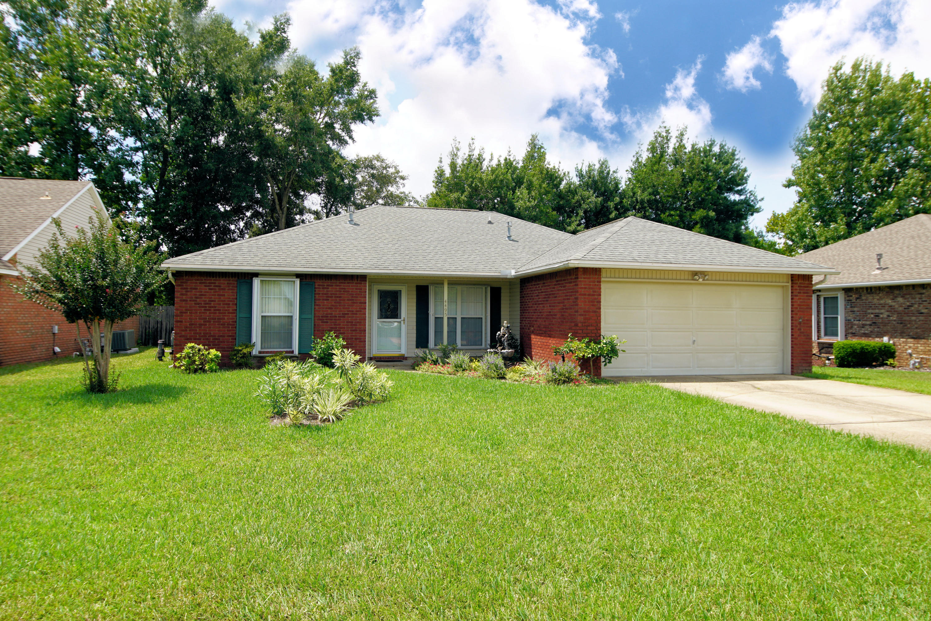 Location Location! This one-story, beautifully landscaped brick home is in popular Bluewater Bay! A high cathedral ceiling greets you as you enter the living room & dining area. The kitchen offers stainless steel appliances and a nice breakfast area with a new light and custom plantation shutters. The split bedroom plan gives the large master bedroom added privacy. The master features a walk-in closet, double vanity sinks & a jetted tub. The other two guest bedrooms share a hall bathroom. The interior laundry room has a washer and dryer that convey. French doors take you back to the screened porch and the fabulous 5 person hot tub where you will enjoy many relaxing hours in the privacy of your back yard. There are hurricane shutters & a 2 car garage. Enjoy all of Bluewater Bay amenities. Buyer to verify all dimensions.