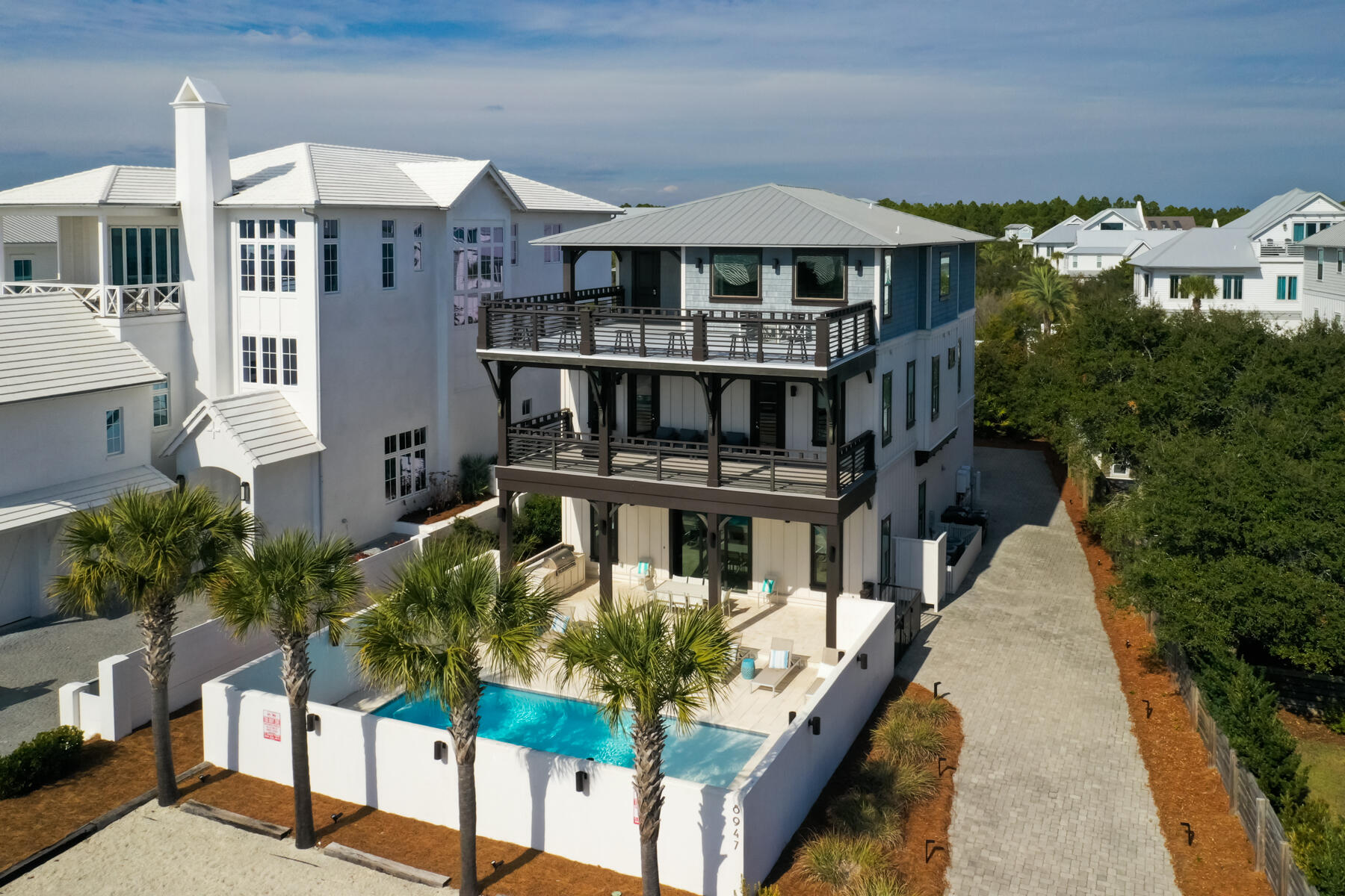 Experience refined coastal living at this exceptional residence, ideally situated within walking distance of the prestigious Alys and Rosemary Beach communities. Designed to accommodate up to 30 guests, the property offers spacious comfort just steps from the renowned white sands and emerald waters of 30A. The interior features elegant herringbone wood tile flooring and a chef's kitchen equipped with premium appliances, including a 48-inch gas range, custom vent hood, dual sinks and dishwashers, multiple ice makers, microwave convection ovens, and three refrigerators. High-end finishes, such as waterfall stone accents and etched mirrored cabinetry, complement the butler's pantry and generous storage, making entertaining effortless. Each of the seven bedrooms provides a private retreat with custom beds, upholstered seating, and memory foam mattresses. The third floor is dedicated to entertainment, offering dual TVs, air hockey, foosball, arcade games, and a kitchenette. Outdoor amenities include gas grills, a resort-style pool, and a fully equipped kitchen, ideal for gatherings.

With its prime location and established rental history, this property represents a compelling investment opportunity, whether for personal use or income generation. Discover the perfect blend of luxury and convenience in this coastal haven.