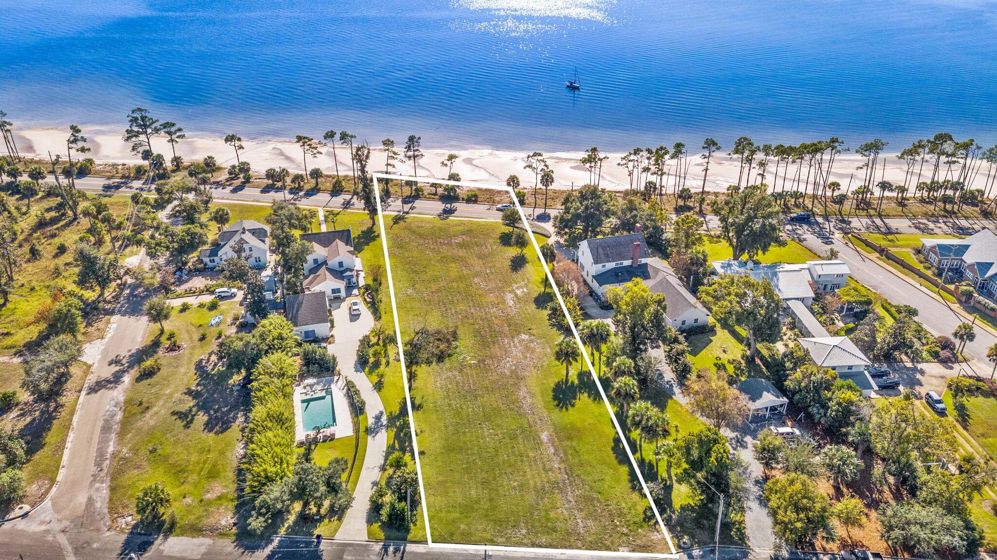 This is your opportunity to own a 1.17-acre, WATERFRONT estate-size homesite on iconic Scenic Beach Drive in Panama City, Florida with NO HOA! Perfectly positioned with stunning Bay views, this exceptional property spans street-to-street and includes two parcels extending down to the Bay, creating a truly unique setting for your future waterfront dream home. 

This size homesite in this location are not available often offering a unique blend of privacy with the homesite size and desirable location in between Historic St. Andrews and Downtown Panama City. With 132 feet frontage, this homesite provides a generous, buildable footprint ideal for an estate-sized home. Zoned R-1 for single family homes, the property is ready for your vision and allows flexibility in design without HOA restrictions. Deeded waterfront access further enhances the value and lifestyle appeal, making this one of the most desirable opportunities along Scenic Beach Drive. 

Ideally located between Historic St. Andrews and Downtown Panama City, this homesite places you at the heart of a vibrant coastal community. Enjoy walking or biking to local farmers markets, breweries, boutique shops, marinas, and a variety of dining options. 

Scenic Beach Drive is known for its bike-friendly streets, community events, parades, and classic waterfront charm. The waterfront lifestyle extends far beyond your backyard. Launch kayaks or paddleboards, anchor your boat for the day, enjoy a refreshing swim, or simply relax and take in the ever-changing Bay views. And when summer arrives, experience one of Scenic Beach Drive's most beloved traditions, Fourth of July fireworks over the Bay...best enjoyed from the comfort of your own home. 

With its rare size, premier location, Bay views, and no HOA, this estate-size homesite offers endless possibilities to create a custom waterfront retreat and fully embrace the Florida coastal lifestyle. 

Survey is available.