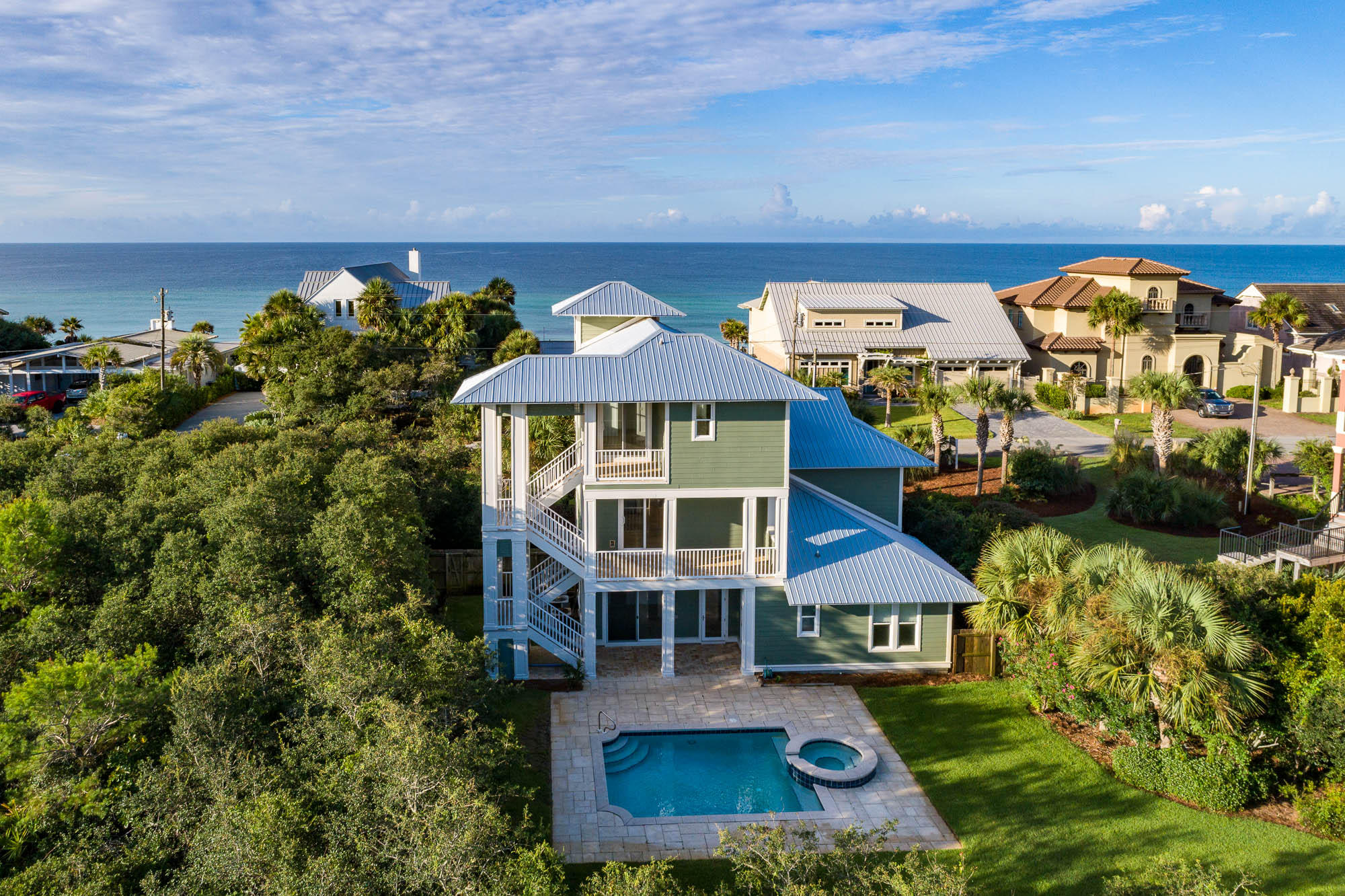 Ideally located south of 30A, just one row back from the Gulf and steps to the beach. Perched for stunning views of the Gulf in quiet Blue Mountain Beach, this beach house offers an open concept that lends itself to entertaining. The main living areas are on the second floor and master on the third capturing expansive water views. Getting to the beach is an easy stroll to one of the neighborhood's deed beach accesses. This well-landscaped and oversized site also has an incredible pool for cooling off on hot summer days. There are two bedrooms and one full bath on the first floor with the master residing on the third. The kitchen is the heart of the second floor and features stainless steel appliances, a wine refrigerator, large walk-in pantry and granite countertops throughout. Enjoy the  Gulf breezes from one of the many porches featured on every floor. The home includes a two-car attached garage as well as a very private and large fenced-in backyard including a hot tub and heated pool. Never been rented and only one owner. Updates include a new metal roof and new exterior paint. Interior upgrades include crown molding throughout, dimmable lighting and a Rinnai water heater. The entire pool and patio area is wired for surround sound, and a convenient outdoor shower is perfect for rinsing off after a day at the beach.  Blue Mountain Beach is a special neighborhood and boasts the highest elevation along 30A, as well as a nice beach lifestyle component with shopping and dining all close by!
