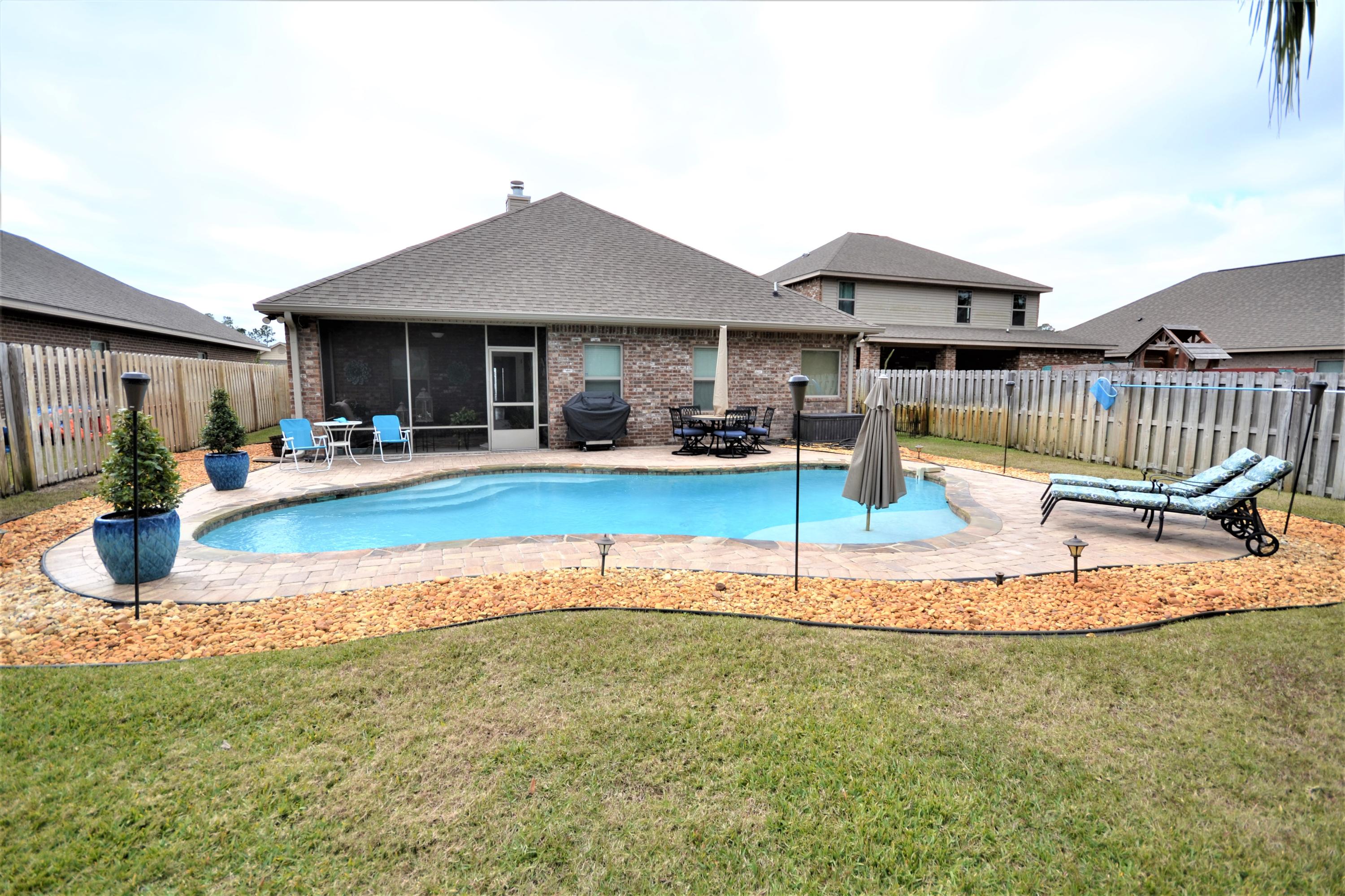 What is this? A Magnificent, STAY-CASION Home with it's own private pool in your own backyard OASIS to include LED coloring changing lights, pool wall jets, also the water ledge feature with umbrella  having within a fully fenced back yard!! Seller is generously leaving all pool equipment, outside furniture. Yard comes equipped with gorgeous settings of PALMS and a FIRE PIT ARRANGEMENT. There's yet lots of yard space for  riding toys, a gym set for many wonderful activities!!
This homes interior has got to be SEEN!!!! This 3 bedroom and 2 Full bathrooms, a HUGE Eat-In Kitchen with a preparation Island. Lots of cabinet storage, a wine nook, a breakfast area. It has a formal dining room now used as a separate Den or too would make a nice Home Office. All upgrade GE Stainless Appliances will convey to include the Washer and Dryer. You'll find a multitude of custom upgrades as you venture through having the wood burning Fireplace with mantle, tray ceilings, crown molding, hardwood floors throughout. The Spaciousness and Natural Lighting inspires this comfortable home.
Has full house security system and cameras with your adding to service. Large television in the Master Bedroom and Great Room will convey. Automatic Sprinkler System. Nice Garage area.