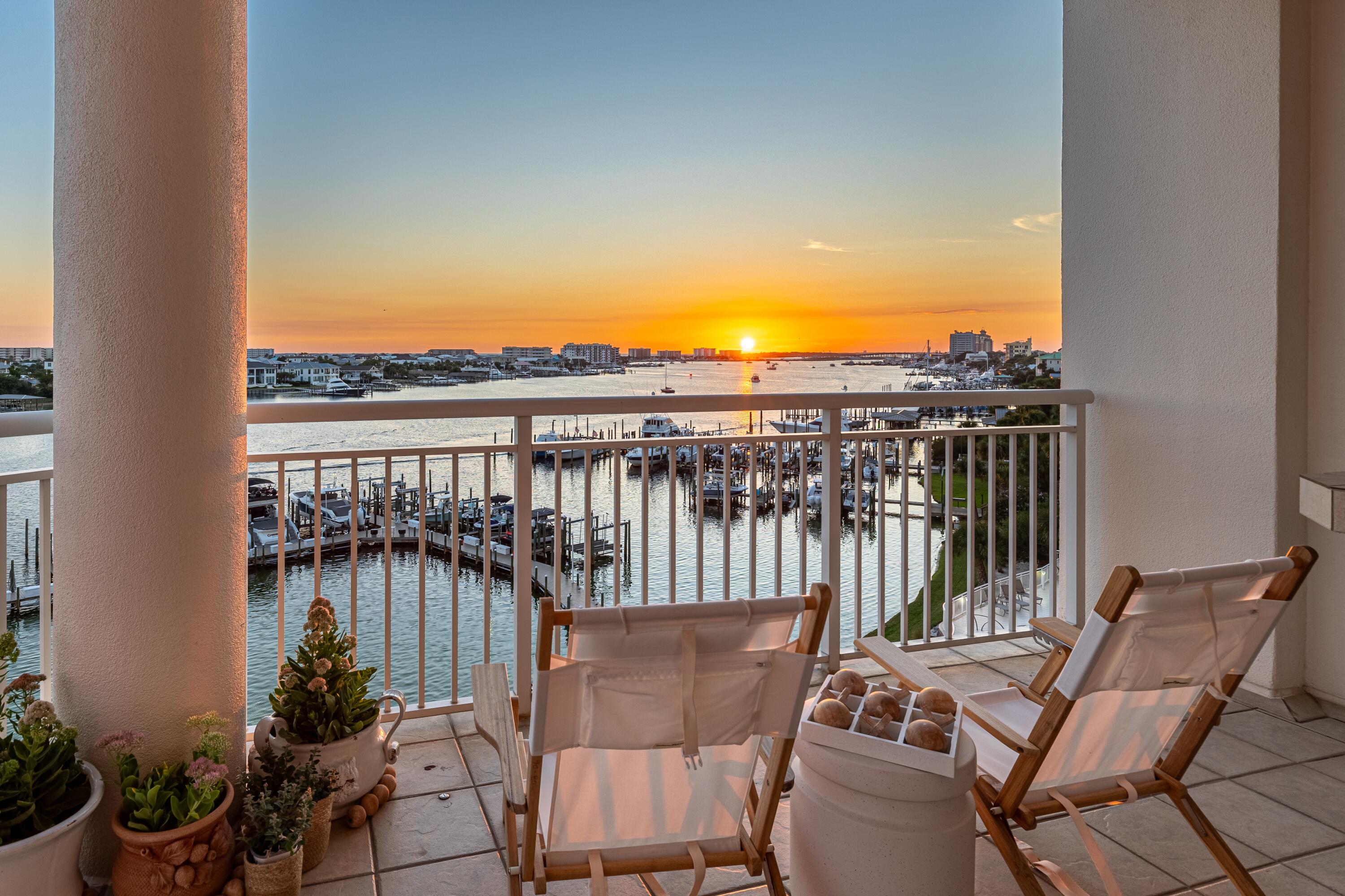 Where Coastal Luxury Meets Everyday Life! Grand Harbor Unit 410 is an east-end 4BR/4BA corner residence redefining Destin waterfront living. Panoramic views of the lagoon, Destin Harbor & Gulf of America set the stage for sunrises, sunsets & fireworks. Renovated with 9.5-ft ceilings, 9'' White Oak flooring, custom coastal trim, oil-rubbed bronze hardware, shiplap, gas fireplace, lounge area & guest suite. Chef's kitchen offers quartz counters, Bosch French door fridge, ZLINE 36'' 6-burner gas range, microwave drawer & pantry with custom wood shelving. Dual walk-in closets & spa bath with concrete vessel sinks, polished nickel fixtures, walk-in shower & freestanding tub overlook the harbor. Enjoy over 300 sq. ft. of balcony space and a heated waterfront pool with hot tub.