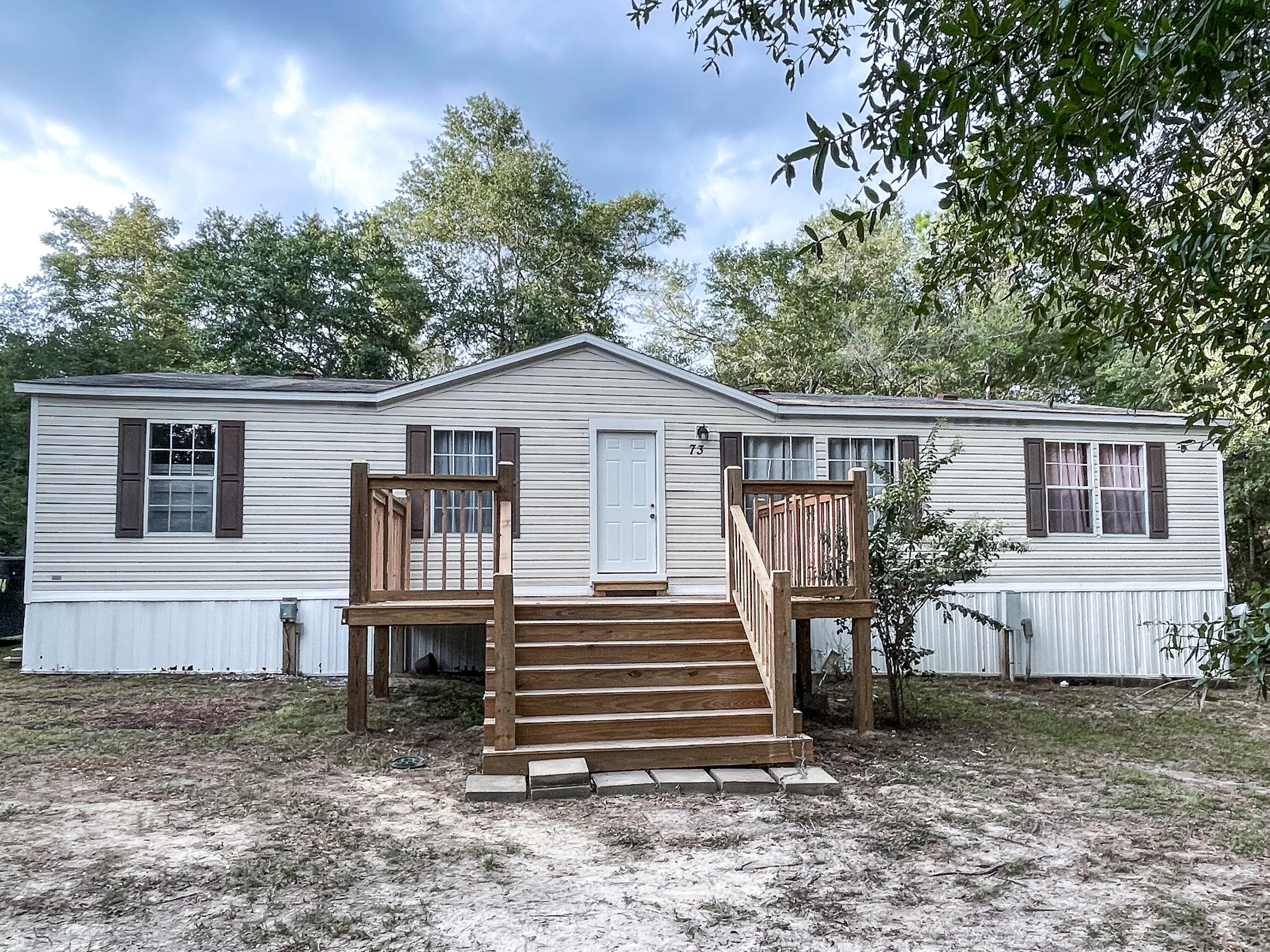 This 4 bedroom 2 bathroom double wide with a split floor plan sits on 1 acre that provides an ample amount of privacy. The living room has vinyl flooring and new paint. It is open to the dining room and kitchen area. The kitchen has brand new appliances, new paint, and a big pantry. The master bedroom has carpet. The master bathroom has a large walk in closet, double vanity, garden tub, and separate stand up shower. The property is partially is cleared, has 2 RV hook ups, and a new submergible pump that was installed this year. Seller is highly motivated!