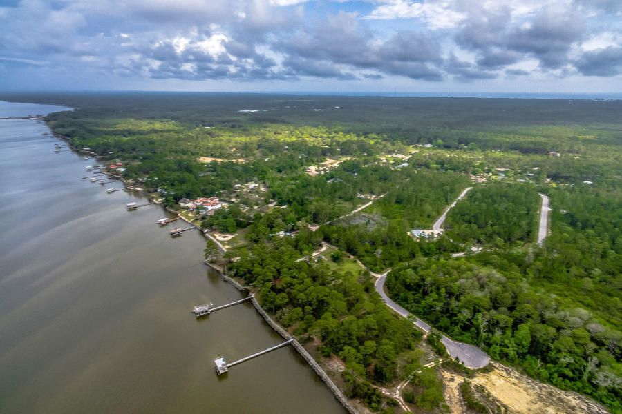 Seclusion Bay is a premier bay front gated community. There is no build out time and tap fees are paid. Minimum house size is 2500 sq.ft. This large lot of almost 1/2 acre gives room for a large home with pool and there is bay access within the community. The community is just a short distance from all that 30a has to offer. It offers exclusive seclusion and is really a part of the whole 30a community. Information is considered accurate but should should always be confirmed by the buyer and his agent. No short term rental allowed.