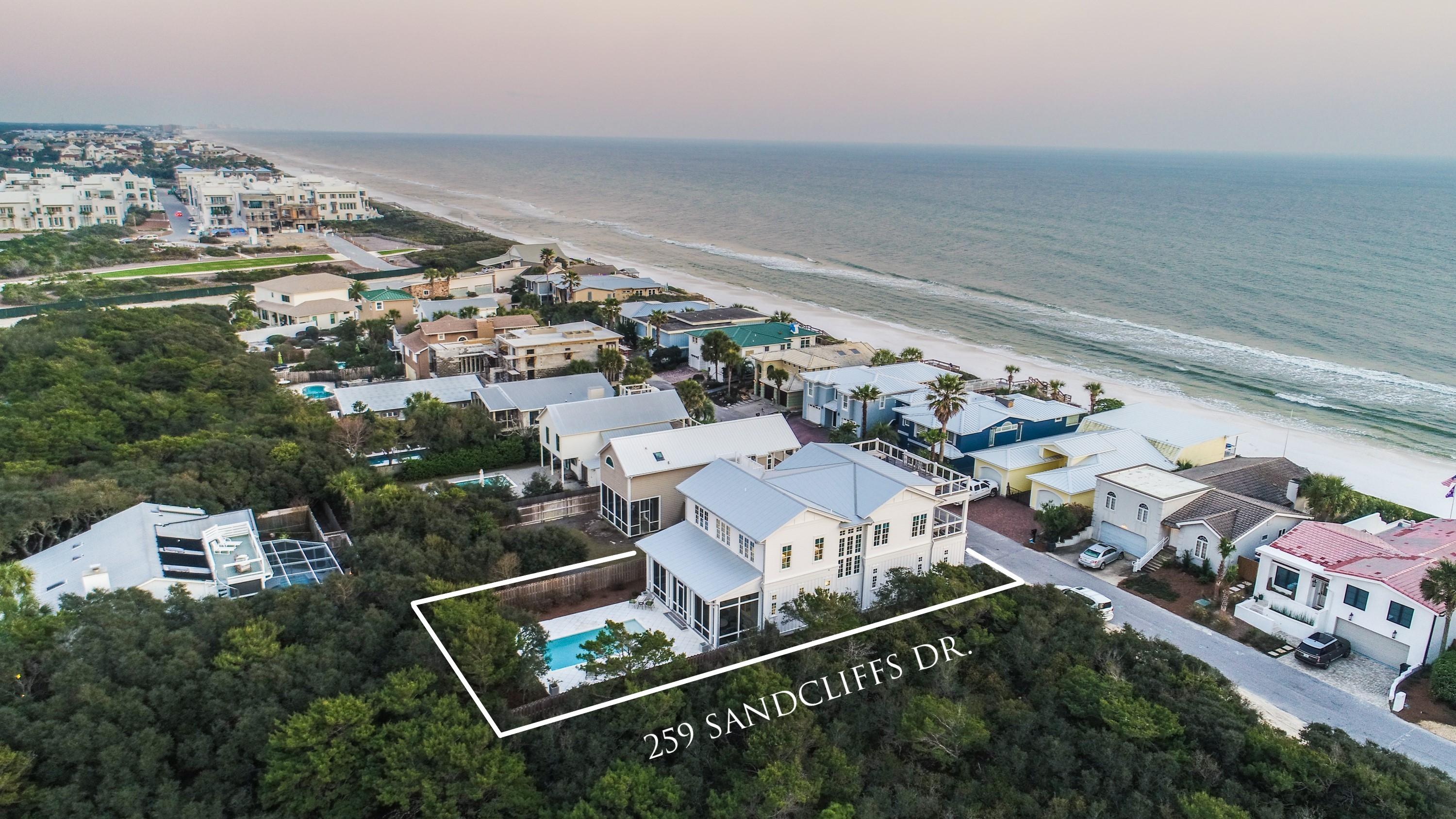Sequestered in the beachside, gated community of Sand Cliffs, this exquisite Geoff Chick-designed home, offers a rare ownership opportunity one off the Gulf of Mexico. This stunning home, welcomes you through a gated entrance into a tranquil courtyard centered with a European fountain that sets the stage for all the artisan details throughout the home. From a third floor roof top terrace, panoramic views from east to west set the stage for a lifestyle of luxury and quietude. This gracious 3,005 sq. ft. home boasts 4 bedrooms, 3.5 baths, and richly appointed interiors with custom designer touches throughout. A reverse floor plan with expansive windows spills an abundance of natural light into the home and frames views of the Gulf. Over-sized two car garages present over 2,400 sq ft with custom storage spaces created for tidy living.  The first level welcomes you with a grand foyer, concrete stained floors, 3 en-suite bedrooms, and a screened in terrace with Cumaru decking that opens to a private back yard with a heated, salt-water pool and spa tub, flanked with stunning peacock pavers.  Walnut plank flooring on the second level, lead to a chef's kitchen that showcases Blum Legra box drawers, quartz-waterfall countertops, Waterstone facuets, Sub-Zero/Wolf appliances, and an Everpure water filtration system.  The open concept great room/dining area and gourmet kitchen, lead to a romantic al fresco terrace for outdoor dining while enjoying inspiring views and sounds of the Gulf.  The owner's retreat completes the second level showcasing a generous walk in closet and master bath featuring an elegant soaking tub, dual vanities and sitting area.
Be the next to enjoy this work of art and the sublime luxury of 30A beach living.