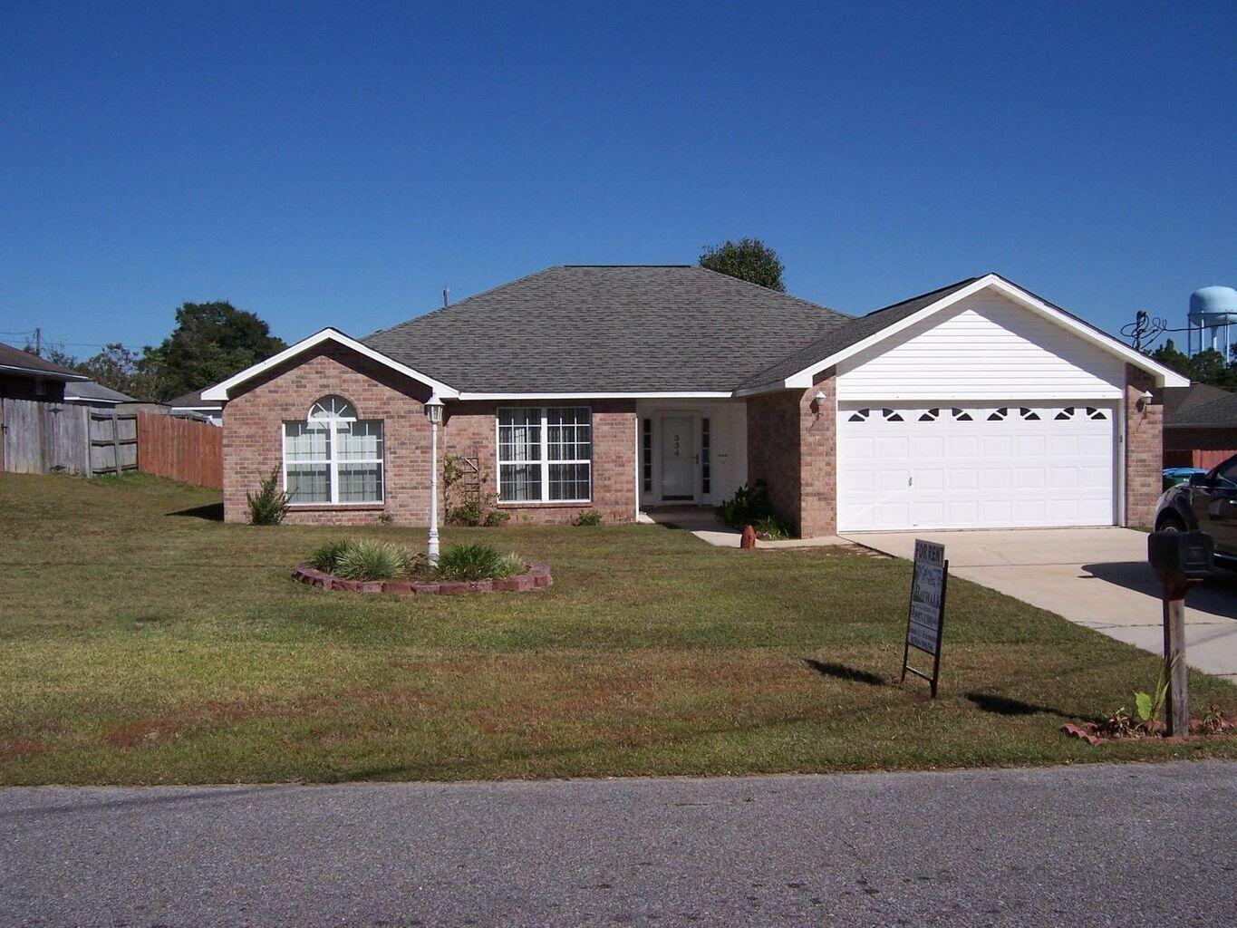Great Home Located South of I-10 in a nice subdivision, zoned to great schools, with no HOA fees! Just a ten minute drive to Duke Field or Special Forces camp this home has laminate wood flooring in living room, dining room and hallway.  The living room features a fireplace and doors leading out to a covered patio and large fenced yard. Primary bedroom with an en suite bath has a separate shower and walk-in closet. The fourth bedroom is attached to the primary suite and could be used as an office, nursery or exercise room, etc. The attractive pricing reflects that the kitchen and bathrooms are original and allows you to make your own cosmetic updates. Take advantage of this opportunity to own a wonderful home in a great location. Come see it today!