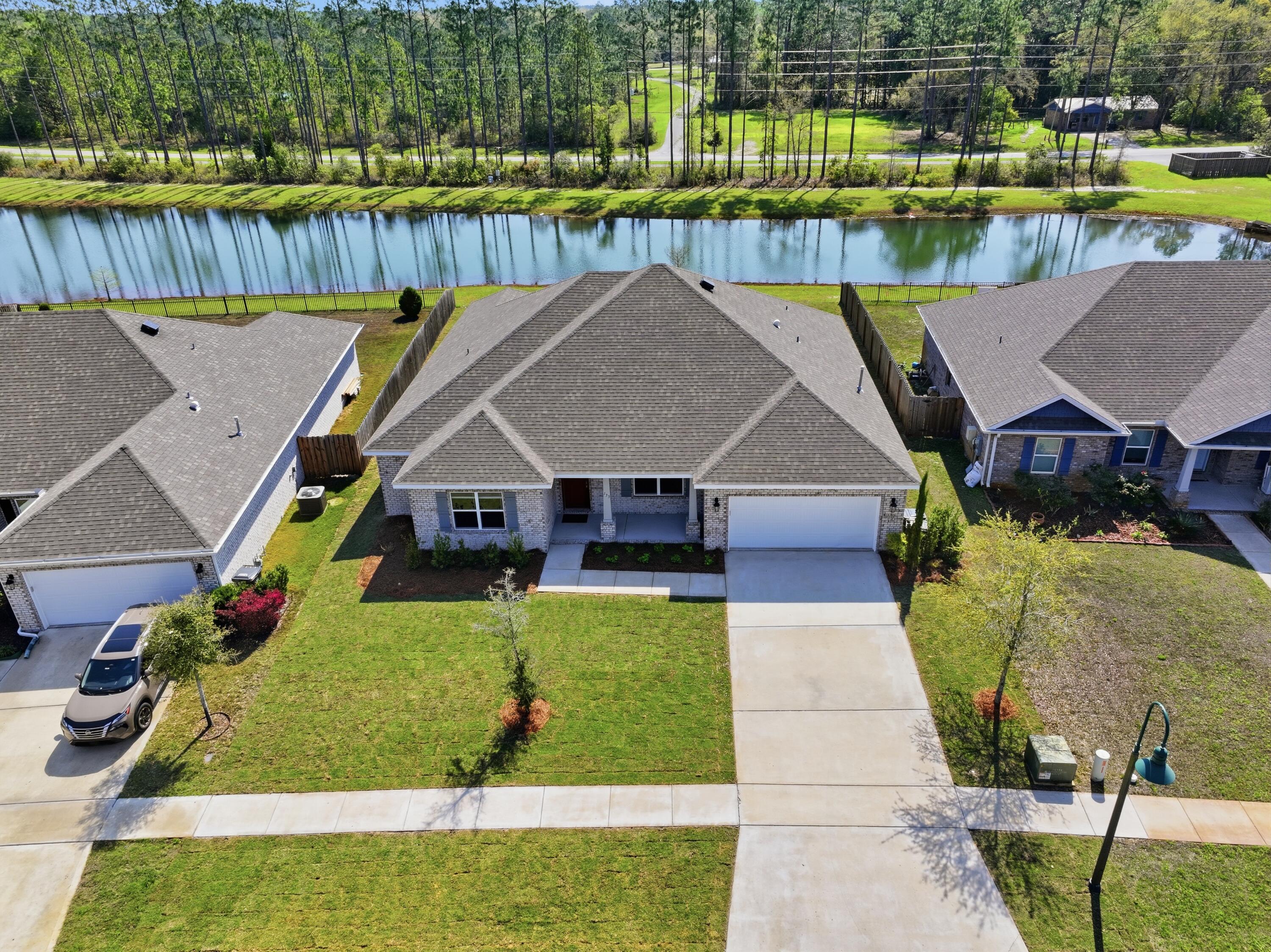 HUGE PRICE IMPROVEMENT!
 Welcome to 133 Sky Way in Hammock Bay, Freeport - a home where space truly opens up your life. Built in 2022 and offering nearly 3,000 sq ft, this brick home gives you room to breathe, room to grow, and room to live the way you've always imagined.
From the moment you step inside, the sense of openness is unmistakable. Four bedrooms plus a big dedicated office offer flexibility for work, guests, or hobbies.
The open-concept living and dining area is filled with natural light, and peaceful water views become part of your everyday backdrop. The kitchen features quartz countertops, a large walk-in pantry, modern lighting,>>> and a gas stove - ideal for anyone who enjoys cooking with precision and flavor. The split-bedroom layout ensures privacy, and the large primary suite includes sitting area, tray ceilings and a generous walk-in closet.
 This home also benefits from approximately $15,000 in recent upgrades (all done in March of 2026), including a brand new well pump, lush professionally installed sod in both the front and back yards, new low-maintenance flower beds, and fresh interior paint throughout. Located in Flood Zone X, the property offers added peace of mind and typically lower insurance costs. A four-car driveway provides plenty of space for family and guests.
Energy-efficient features - including double-pane low-E windows, modern insulation, and an efficient HVAC system - help  keep the home comfortable year-round.
Living in Hammock Bay, residents enjoy 3 resort-style pools, a large fitness center, clubhouse, sports courts, playgrounds, dog parks, pickle ball and tennis courts,  miles of walking and biking trails, a general store, a food-truck court, and regular neighborhood events! Wide sidewalks and beautifully maintained common areas make it easy to enjoy the outdoors. Proximity to iconic Gulf Coast spots: Blue Mountain Beach, the Gulf of America and its white sand, top entertainment, stunning State Parks along Scenic Highway 30A, and the Choctawhatchee Bay are all just 15-20 minutes away.
If you're looking for a home that blends a lot of  space, comfort, peaceful views, and an exceptional community, 133 Sky Way delivers it all with ease! Schedule your showing today!