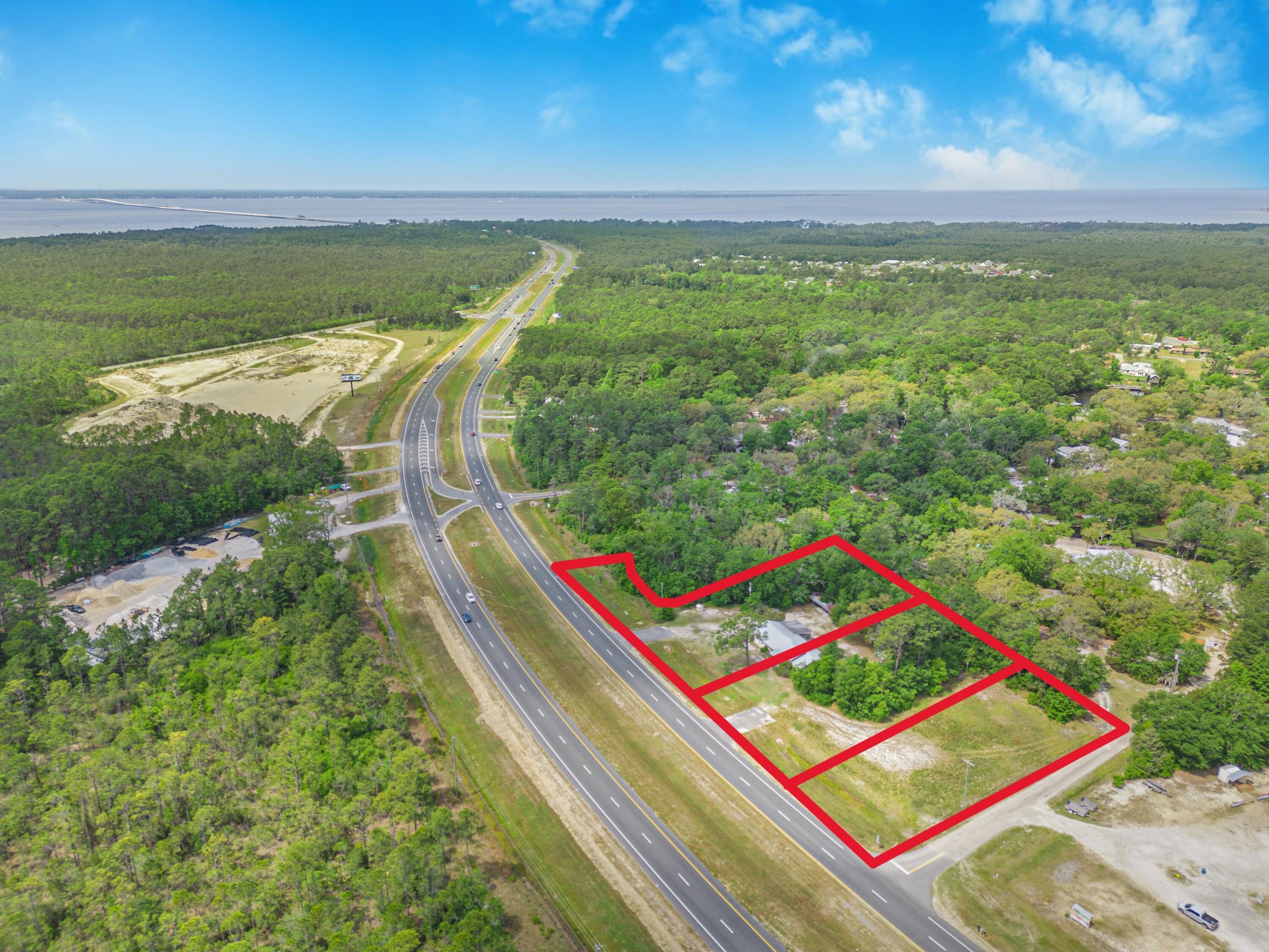 Investors what an opportunity ...Frontage on US HWY 331 with public water and sewer available in Freeport, one of the fastest growing areas in Florida. Current  Rural Village zoning allows for many commercial business ventures including: Professional offices, restaurants, retail stores, medical offices, lodging, and several more options we can share with you. General Commercial zoning is an option if you choose to pursue it. This property includes three full lots with a  3 bedroom/2 Bathroom 2207 square foot brick home.(Potential Office Space) The interior offers a spacious kitchen, large flex space, tastefully updated bathrooms, tile and laminate flooring, and an amazing wood burning fireplace with an exterior load option. There is currently a 300 foot well and septic tank in place. Additionally, outside there is a covered patio, RV hanger, and greenhouse.  The home also has a metal roof (20 years old), a tankless water heater (5 years old), and an HVAC (6 years old). The options for this property with its location in Freeport, and proximity to the bay make this a rare find! The city needs many businesses to support its incredible growth! 

As of 10/1/23, within the city limits of Freeport we have approx. 4,260 households (x 3 pph*) = 12,780; Residents just outside the city limits/within Freeport Service area; 4953 Households (x 3 pph*) = 14,859.  All combined has the Total Freeport Community Population at 27,639. Notes from City of Freeport BIA meeting...*FDEP (person per household) multiplier: 3  

We are not done yet!!  There is much more to come... As of 10/1/23, there are 5,870 Single Family Residential Units approved*, 1,764 Multi-Family Residential Units approved*.  This does not include the Master Planned Development units/square footage which has not yet been submitted for review. 

Approved development orders issues for 2024 include the following: 
-Custom Portable Buildings of the Panhandle 
-Old Miami Residences - 6 Townhome Units 
-Express Oil Change (5,673 sqft facility) 
-Chelco (28,638 sqft Operations & Service Center Facility & 1000 sqft Storage building) 
-Hwy 331 Retail Center (18,030 sqft retail, 7,727 sqft restaurant, 1,228 sqft outdoor seating, 2,155 sqft future drive-thru restaurant) 
-Bay-Kissed Holiday Interest - Vending permit for tree sales 
-Freeport Community Center (4,000 sqft) 
-Genoa Landing Phase I  (68 Townhomes Units) 
-The Waters at Freeport Multi-Family Development (226 apts, 8,389 sqft of Clubhouse, 1,957 sqft     pool, 1,200 sqft maintenance bldg) 
-Freeport of Florida POP (350 sqft Presence Facility for Uniti Fiber) 
 
2024 Subdivision Record Plats: 
Single Family Owls Head Farms Phase 1-A (42 SF units) 
Single Family Owls Head Farms Phase 1-B (148 SF units)