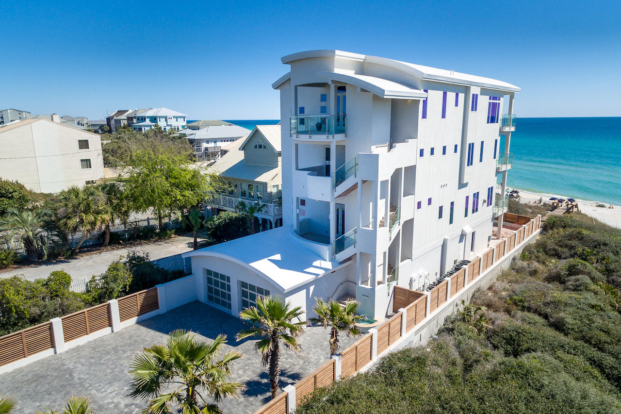 Stunning is an understatement: Four stories of pristine Gulf views, exceptional amenities and impeccable design. This contemporary Gulf front oasis known as Sea la Vie has over 7,800 square feet of open living space and luxury accommodations like a beautifully designed custom pool with a sun shelf and spa (nearing completion), a private beach walkover and a penthouse with panoramic views of turquoise water framed by sugar white sands. An entertainer's paradise  this home features 2 full gourmet kitchens, a home theatre, 3 wet bars with temperature controlled wine coolers and 2 spacious open living areas. Both gourmet kitchens feature Wolf stainless steel appliances, a Sub-Zero fridge, a large butler's pantry and a breakfast bar. The third floor holds 2 master suites with secluded private balconies, a midnight kitchen, spacious walk-in closets and upscale master bathrooms with steam showers and large Kohler soaking tubs. The layout of this seaside estate is great for intimate gatherings with friends, or transforms into an exceptional venue for hosting large events. Sea la Vie offers ample parking with an attached 2-car garage and an additional 5-car gated motor court.  
Not only does this modern mansion have exceptional amenities, but it also has upscale finishes and features that complete this spectacular home. Hardwood flooring, Limestone tile, stainless-steel faucets, custom light fixtures, 15' raised ceilings and Quartzite kitchen and bathroom countertops are found throughout.