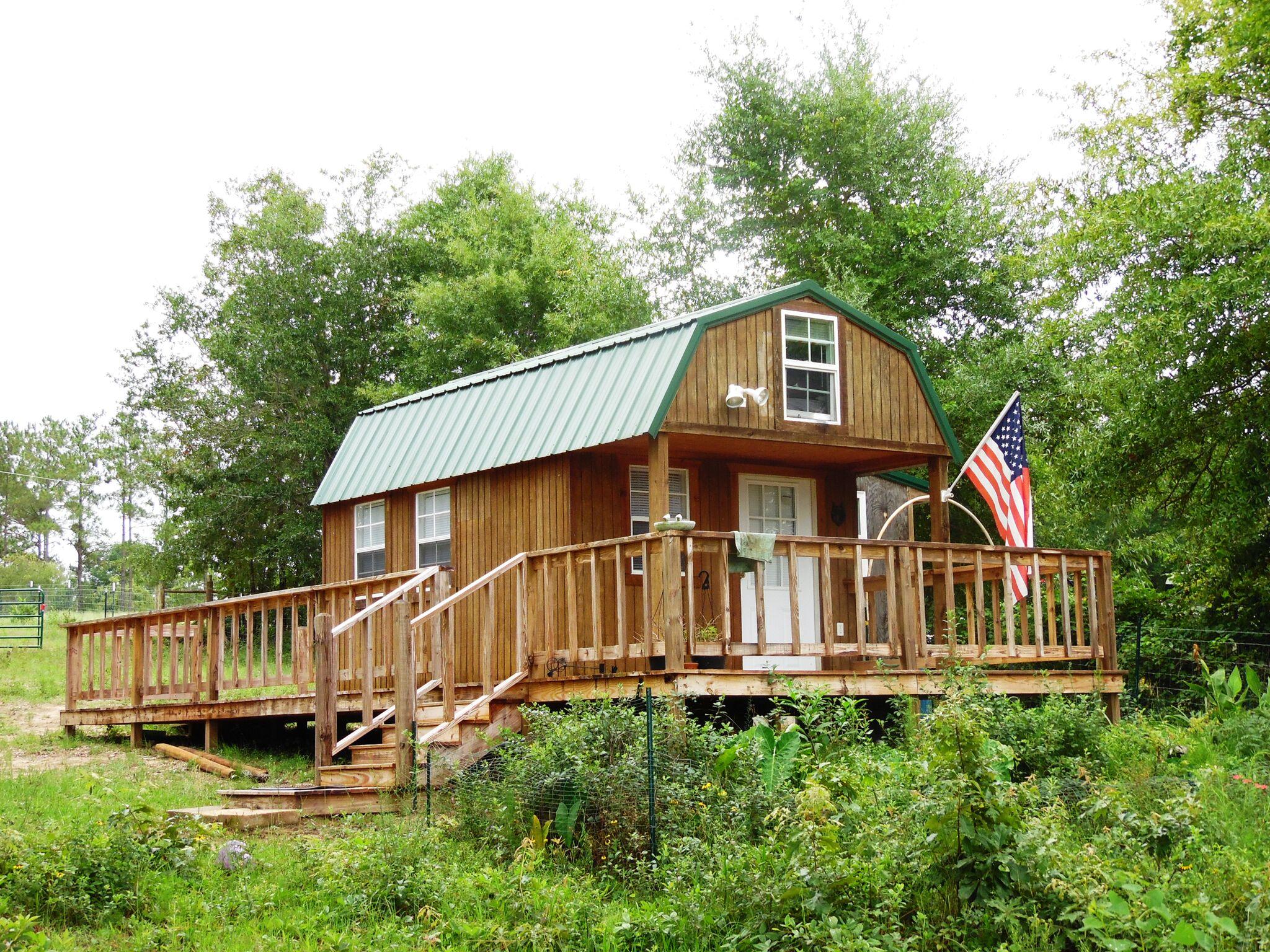 Cabin on Kings Lake- 2.9 acres ...Weekender private...every fisherman's dream of a waterfront weekender cabin, also has ''hook-up: for an RV....perfect for your RV's campsite/home base. Fenced for horses on this 2.9 acres on Kings Lake..waterfront --- complete with 3 pole barns...so bring your horses, pole barns, boat sheds, decks, and dock . Asphalt chip top private on Nellie Paul Road entrance road. So much for such an affordable price.. just plain cozy. Complete with 2 loft beds, full bath, kitchenette complete with refrigerator, microwave, toaster oven, and small stove. Plenty of room to build your dream home above the cabin!