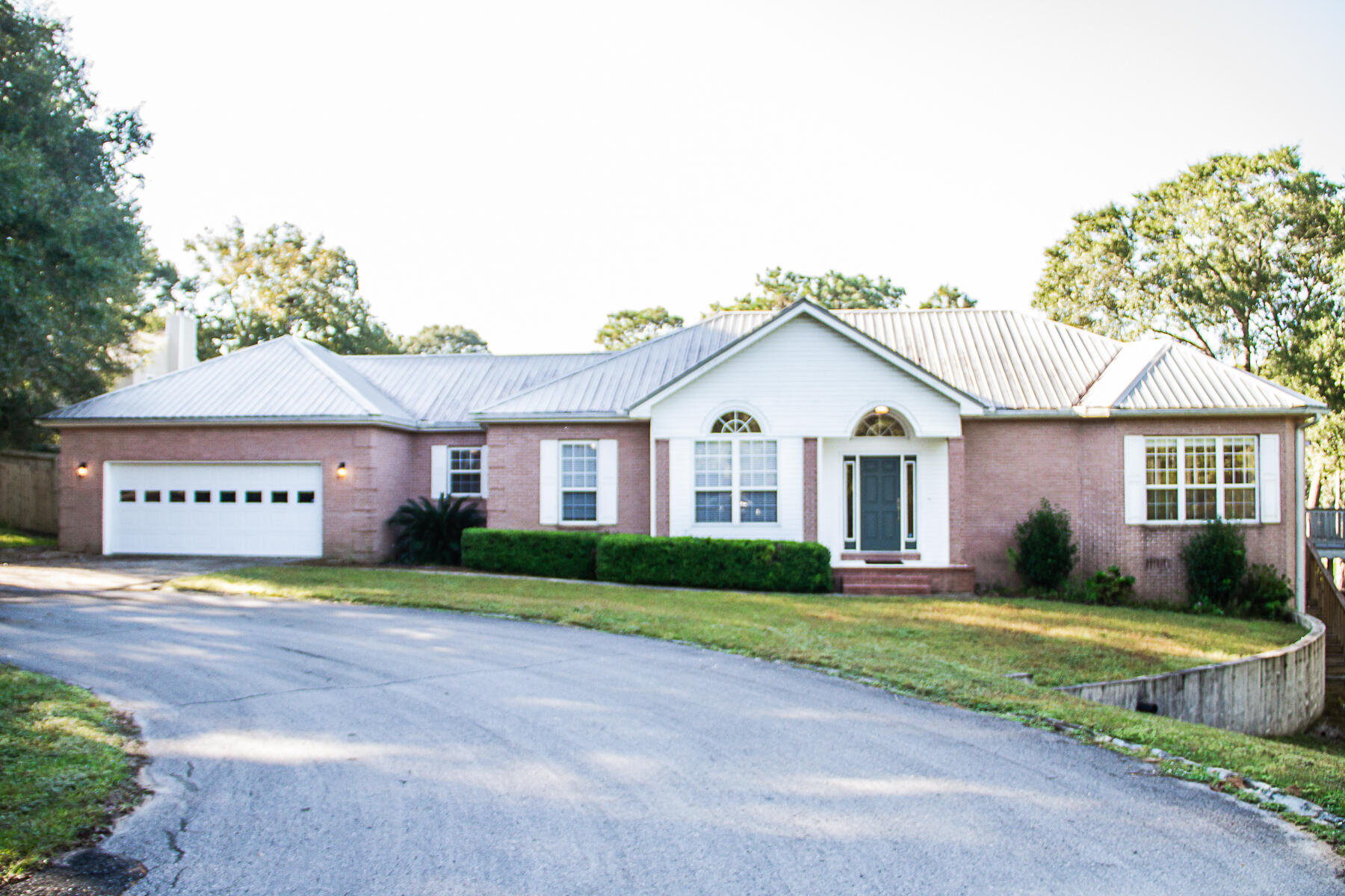 Available 11/5/21...South Crestview & lakefront living.  3/2 home boasts 65 feet of lakefront, as well as a double-level deck to enjoy your views. Over 2000 sqft. of living space.  The foyer opens into the large living room w/fireplace, also featuring dining area, breakfast bar all w/lake views. The kitchen has a center island & large pantry.  Nice parquet flooring is featured in all living areas, w/hardwood in the bedrooms and tile in the bathrooms. Workspace in the garage is available and a plus, this 29' long garage with its own mini-split system to keep the temperature comfortable no matter what time of year.  Privacy fenced back yard, courtyard, 2 open decks, fishing, cul de sac, lawn care included, washer and dryer included.  No inside smoking/vaping.  Pet's allowed w/approval.