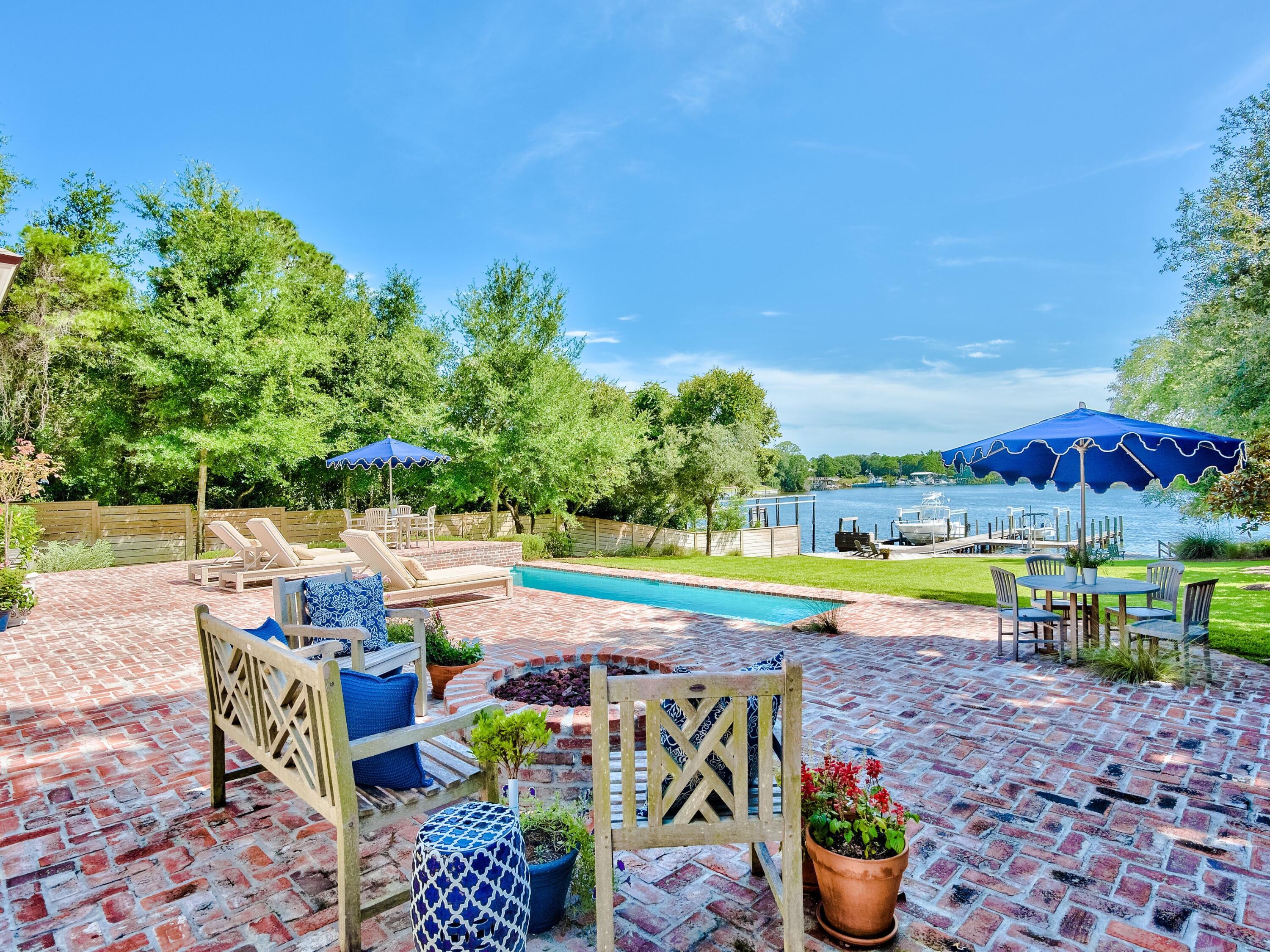 Privacy and quality abound throughout this sprawling five-bedroom waterfront estate on Joe's Bayou, offering a peaceful deep water ownership experience for discerning buyers who simply demand the best. Expertly designed and built by Reiker Homes, this builder's showcase home offers an ultra-spacious footprint, measuring 6,456 square feet, primarily all on one level. Accentuated by breathtaking water views from the living spaces, as well as the oversized master suite with a custom curved wall design, and two private office spaces, this prominence of this Craftsman-inspired Southern estate home is truly spectacular. Aged French Oak flooring is showcased throughout the home providing warmth and additional depth to the high ceilings, while custom tilework is displayed in each bath as well as the beautiful chef's kitchen. The formal dining room is accented with a decorative ceiling, offering artistic appeal to the designer property, while quartz countertops, Thermador appliances, and a spacious butler's pantry offer convenience and tranquility for all who spend time at the home. 

Upstairs, an oversized bedroom with an ensuite can be converted to additional entertainment, game room or office, perfect for those looking for space, privacy and flexibility. 

Transitioning to the exterior of the home, the water-front outdoor living spaces surrounding the brick paver pool and spa are truly exceptional. A fully covered summer kitchen with al fresco dining and living spaces is sure to delight those in search of ideal transitional spaces, while the oversized private dock with two boat lifts, and jet ski lift was designed with water lovers in mind. 

For the ultimate lifestyle property, showcasing the best of what the Emerald Coast has to offer, look no further than this exquisite offering on Joe's Bayou.