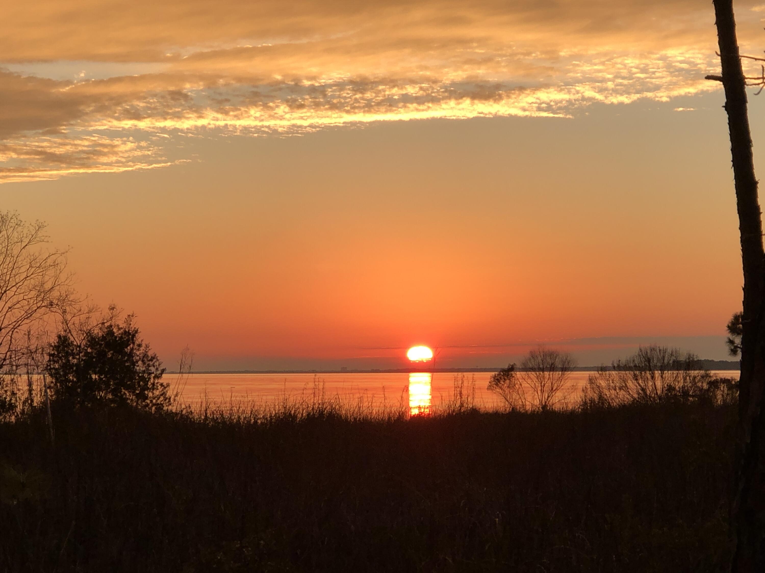 This is a rare opportunity to build a large waterfront home in Bluewater Bay. These combined lots and parcel are approximately 1.84 acres. Enjoy amazing sunset views from your back porch and fish off your private dock on the Choctawhatchee Bay. The owner will have deeded access to build a walkway over the wetlands to a private dock on the bay. Build a large private home with amazing sunset views. Wetland survey is attached in documents section. This property is an AE 7'-8' flood zone. We can recommend an excellent builder to build your dream 
waterfront property.