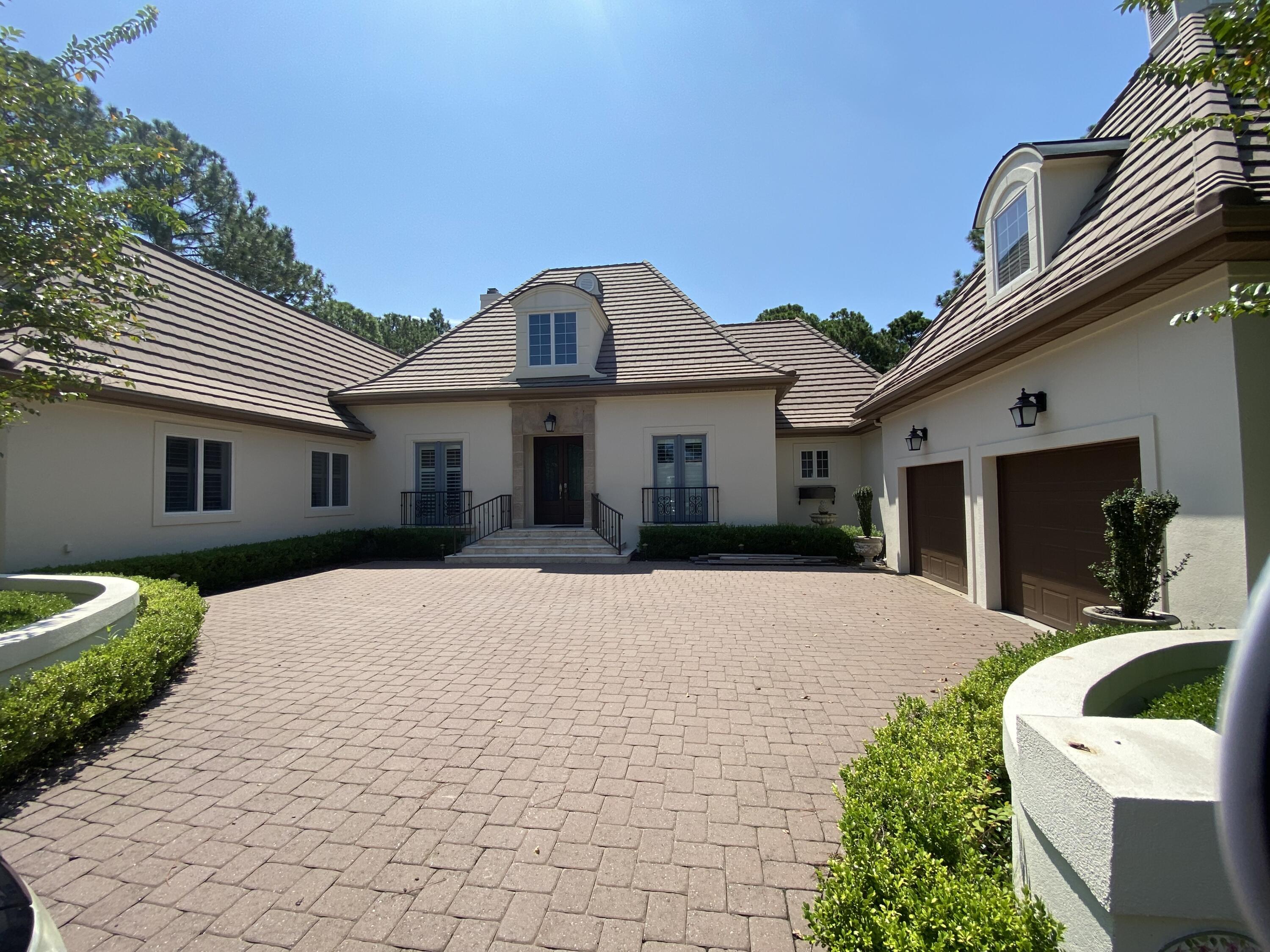 Country French inspired home is nestled on an estate size lot in a private cul de sac in the exclusive Burnt Pine neighborhood within Sandestin.