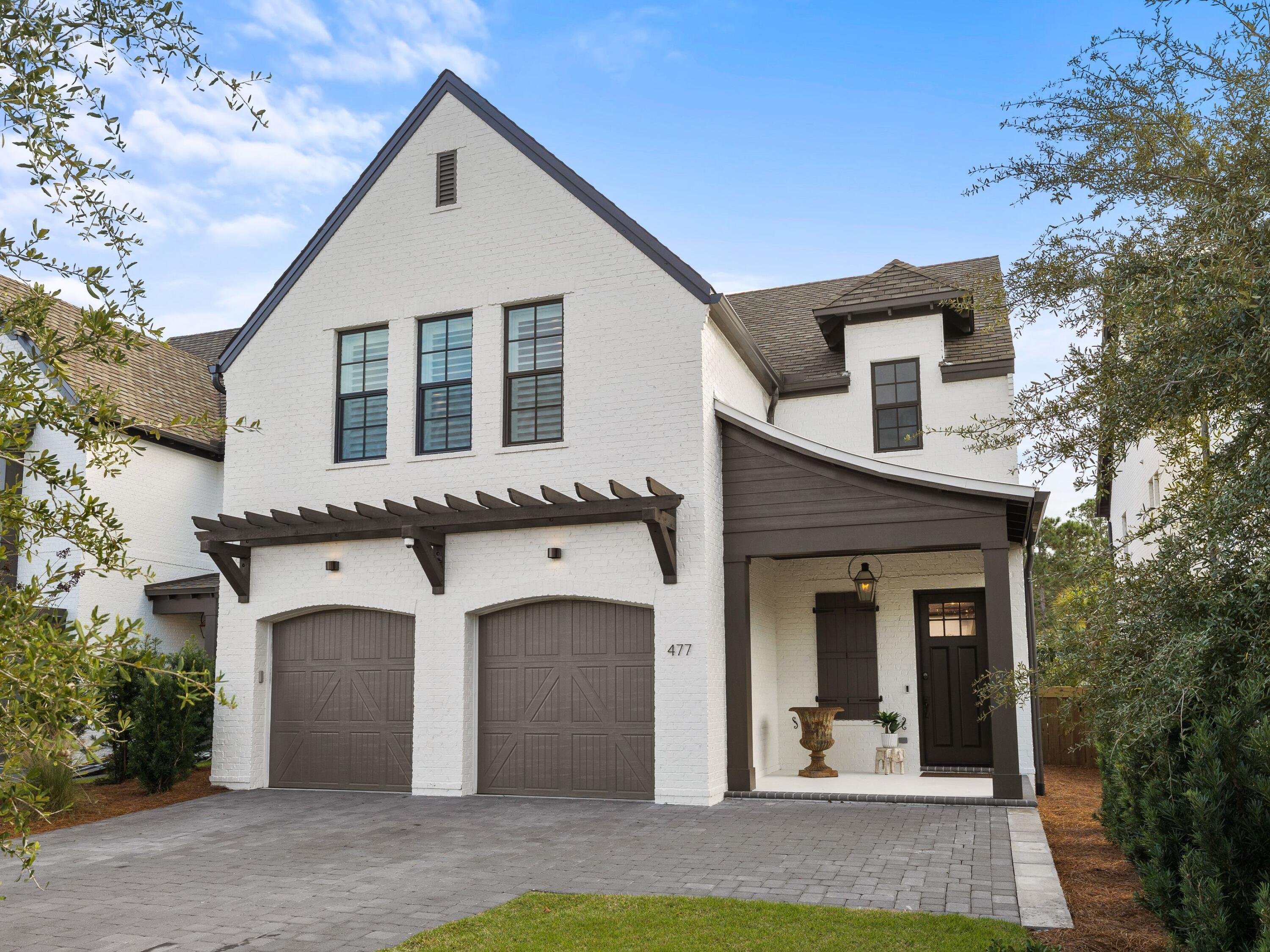 Located in the brand-new upscale community of RidgeWalk, this outstanding home has a plethora of custom upgrades to the original plans including an elevator, additional closets and a bonus office. Custom window treatments, Roman blinds, accent walls and plantation shutters are just part of the high-end finishes rarely found in newer homes. This characterful home is fronted by a full-width brick paver driveway for multiple vehicles and craftsman-style doors to the two-car garage. A covered porch shelters the main entrance door. Mellow wood flooring, an exposed brick fireplace and lap-and-gap accent walls grace the nicely proportioned living area of this quality home. The light open space is enhanced with country farmhouse-style features on the kitchen island, which houses an apron sink and dual-drawer dishwasher. There's a full range of built-in Fisher and Paykel appliances and a handy pot filler over the stove. LED under-cabinet lighting highlights the quartz countertops. This gourmet space is complemented by a butler's pantry which doubles as a wet bar and coffee station. Doors lead out to the covered terrace with steps down to a fire pit and barbecue area in the generous lawned yard. The master suite deserves a second look with its brick accent wall and master closet/dressing room. It includes a chest with soft-close drawers and built-in bench seating. Modern technology is fully embraced with video security, a full house generator with Wi-Fi, automatic Wave Lighting system indoors and outside, tankless water heater and a central vacuum. Entertain with your own choice of background music via surround sound speakers in the living room and a Russound audio system extending into the bedroom, bathroom, kitchen and back yard. RidgeWalk is less than a mile from beach access, Gulf Place shopping and popular dining establishments. This gated, rental restricted neighborhood includes a community pool and pavilion with a fireplace for social gatherings.