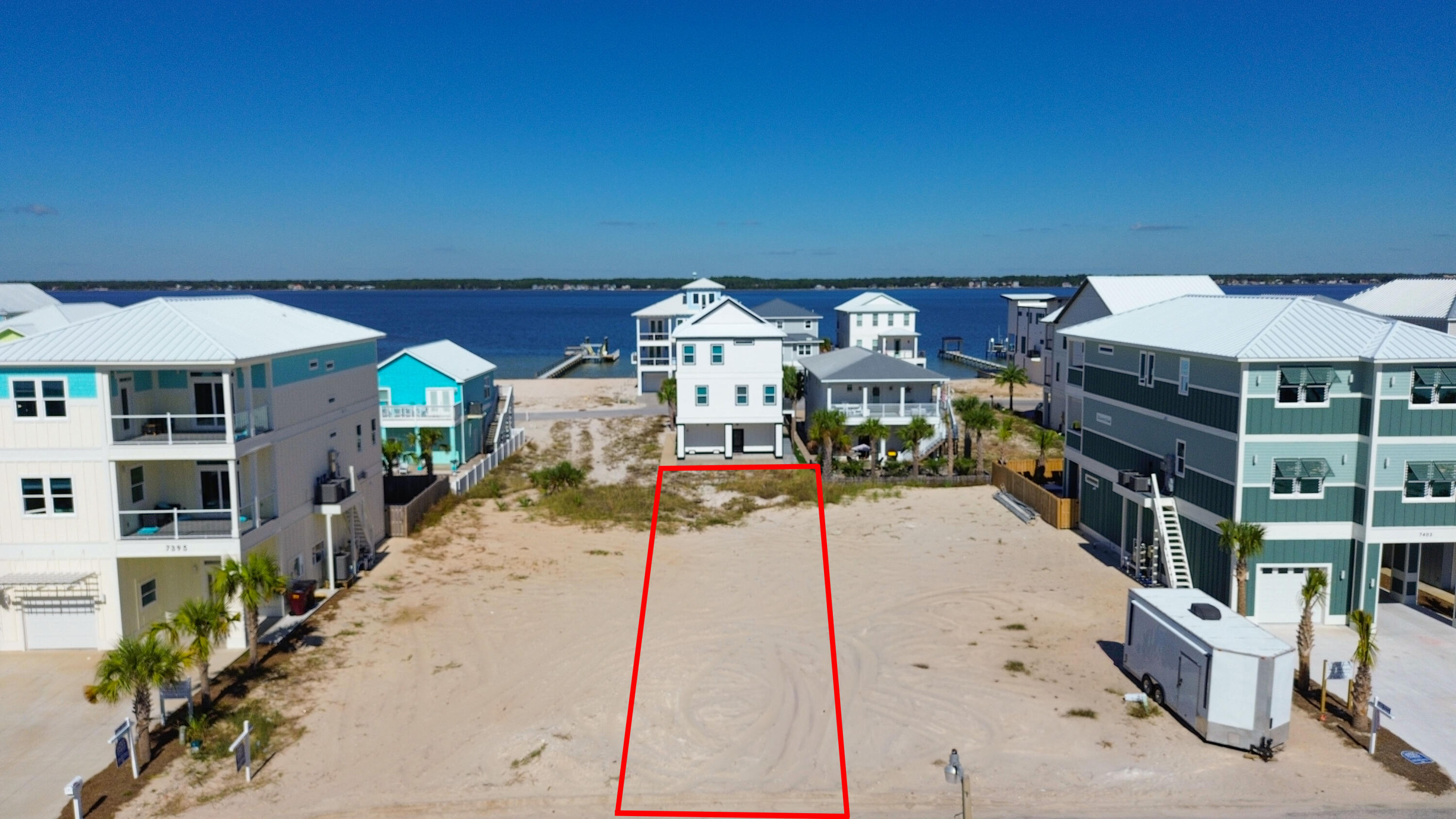 BUILD YOUR DREAM!! Imagine waking up to gulf breezes, stunning sunrises and sunsets, within minutes of public beach access to the sugar white sands and turquoise waves with this premier lot. This is one of Navarre Beach's most desirable addresses. Whether you dream of a stylish coastal home, a vacation rental gem or your forever retreat, this clean canvas gives you that option. Blending outdoor adventure like paddle boarding, kayaking, surfing, boating, jet skiing to enjoying coastal nature with sea turtles, dolphins and pelicans. There's freedom with no HOA, short term rentals allowed and public utilities. Plenty of opportunity for residual income or your primary piece of paradise. Minutes from dining options include Andy D's, Beach House Social Bar & Grill, Juana's and Windjammers. From live music enthusiasts to beach dwellers, the coastal life has so much to offer. Nearby bike/walking paths, Sea Turtle Conservatory, boutiques, golf cart rentals and coffee shops. Start your day with breathtaking sunrises, walks or yoga on the beach, finding the perfect seashells, bike rides through the community to ending the amazing day to a glass of wine, some sweet tea, entertaining friends and family while the sunsets and you take it all in. HWY 98 is a short distance off the bridge to top rated schools, Walmart, Publix, Winn Dixie, hospitals, shops, other dining options and local favorites like Stripes and Tommy's SnoBalls. Builder renderings available and can be customized. Your slice of paradise is waiting, let's build your beach story.