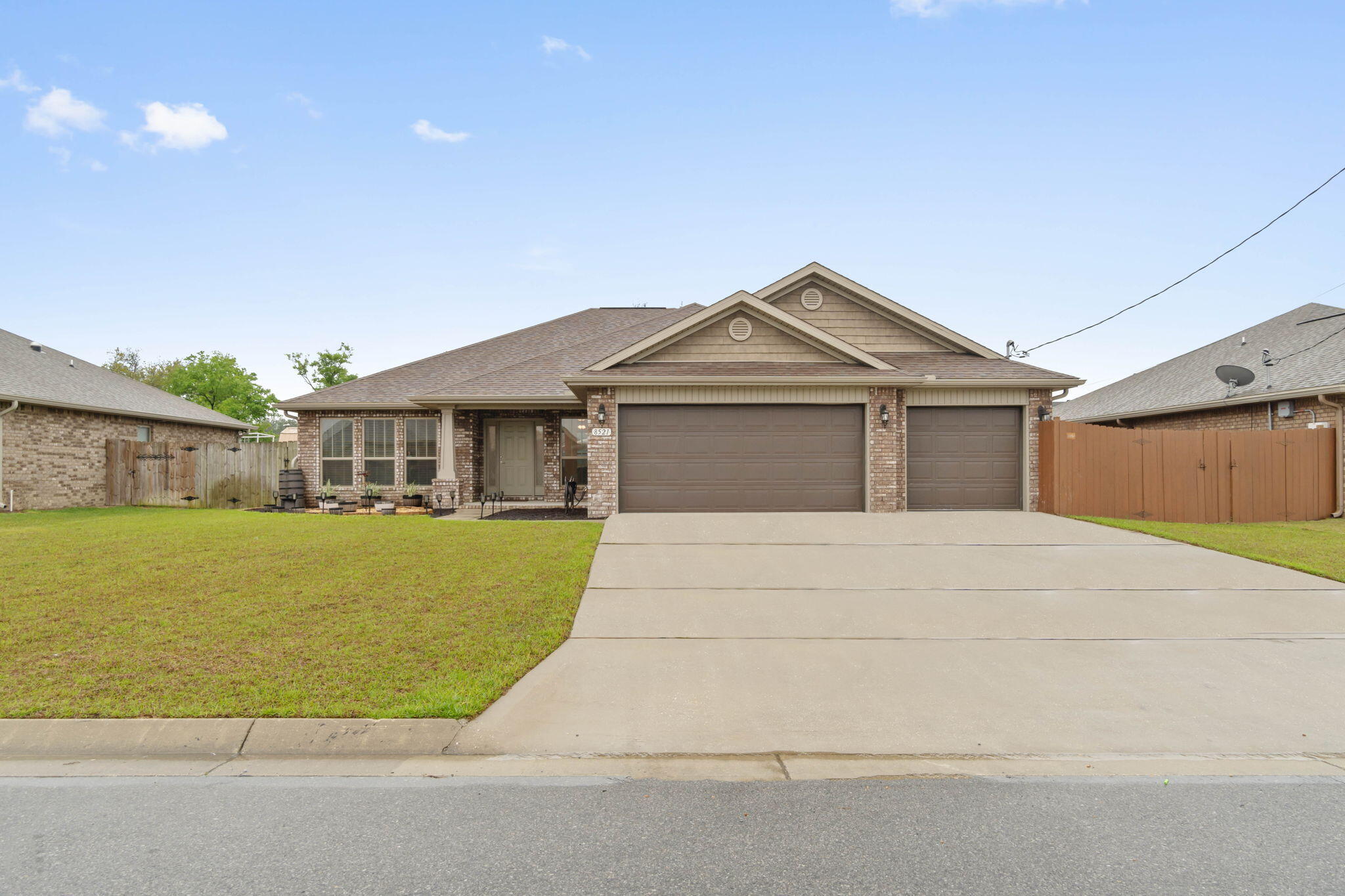 Welcome home to this stunning all brick home with a 3 car garage in the much loved neighborhood of Holley Hills! Featuring 4 bedrooms, 3 bathrooms, an office, formal dining room, AND a flex room - this practically new home surely has all the space you've been looking for! This fantastic floor plan features a split layout providing master bedroom privacy, but also has a separate wing on the other side of the home for one of the additional bedrooms with its own bathroom! Pull into the massive driveway and you'll appreciate the updated landscaping, and pass through the covered front porch to find soaring 10ft ceilings in this open concept plan along with great upgrades like bull nose corners in the living areas. To the right when you enter is the formal dining room, and to the left through the sliding barn door is a great office space that could also be converted into a 5th bedroom! The large living room is open to the well appointed kitchen where you'll find a functional and fantastic sized kitchen island, granite countertops, stainless appliances, drop down pendant lighting, additional recessed lighting, and a pantry which is open to the eat in kitchen area.  As you walk to the owner's suite you'll find a fantastic flex room (currently used as a playroom) with a door that leads to the covered back patio within the fully fenced in backyard. The great sized master bedroom features a trey ceiling and a stunning en suite bathroom complete with TWO walk in closets, double vanities, a private water closet, a separate soaking tub, and a HUGE tiled shower with TWO shower heads! Two of the additional bedrooms are located on the other side of the house together each with ample closet space, and down that hallway is a full bathroom with a door that leads onto the back patio! The fourth bedroom is down its own hallway and has its own wing of the home with another full bathroom! The interior laundry room (washer and dryer will convey!) leads to the large 3 car garage. Enjoy being minutes to Navarre's beautiful beaches and a short commute to Hurlburt Field. Have peace of mind with a termite bond and a 22kw Generac generator that will convey with the home! Don't miss the full list of seller updates!