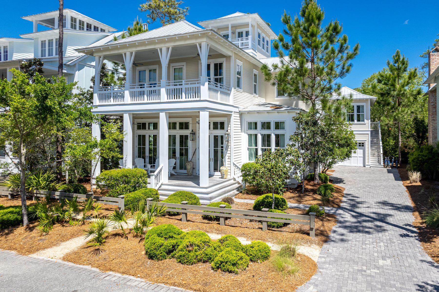 Nestled in the picturesque Lake District of Watercolor, 102 Vermilion Way offers a serene and private retreat, bordered by a nature preserve. This three-story Romair-built home was meticulously designed by Bella Beach Interiors and boasts a broad welcoming front porch as well as an observation tower to take in the breathtaking views of the neighborhood.
 
Step inside to be bathed in natural light from multiple floor-to-ceiling windows in the spacious great room. The adjacent gourmet kitchen, equipped with high-end Wolf and Subzero appliances, dual sinks, and a wine cooler, is the perfect space to entertain the whole family. Beautiful quartz countertops extend onto the expanded island, complete with seating. Adjoining the kitchen is the butler's pantry and laundry room, featuring a double set of washers and dryers, a wine fridge, and a half bathroom. Experience outdoor living with over 1,000 square feet of porches, an inviting outdoor fireplace and summer kitchen.
 
This luxurious residence boasts five bedrooms and five and a half bathrooms, as well as a bunk room with double bunks. The main level primary suite features a spacious walk-in closet, an ensuite bathroom with twin vanities, a tiled shower, a marble-edged soaking tub, and doors that open directly to the screened porch. 

On the second level is an additional primary suite with private balcony access and ensuite bathroom. Down the hall, you will find the bunk room with two sets of bunks, and two king guest bedrooms, both with ensuite bathrooms and balcony access. Guests will enjoy the screened balcony, complete with a swing bed overlooking the nature preserve. The generously sized lot provides ample parking, with an attached single-car garage and a carriage house above, offering guests a cozy retreat with king-sized bed, a full bathroom, and a beverage station/bar with built-in refrigerator. 

Watercolor offers a variety of amenities including 10 pools, with the Frog Pool being the closest. Take a leisurely stroll or bike ride across the Western Lake bridge to paddleboard from the community Boat House. Continue your stroll to the exclusive Watercolor Beach Club, where three gulf-front pools await you. Enjoy sunset dining on the terrace and easy access to the pristine white sandy beach. Additional amenities include Camp Watercolor, tennis and pickleball courts, and several meticulously maintained parks and trails. Explore the Watercolor shops and restaurants or venture to the neighboring communities of Seaside and Seagrove for a diverse range of activities!