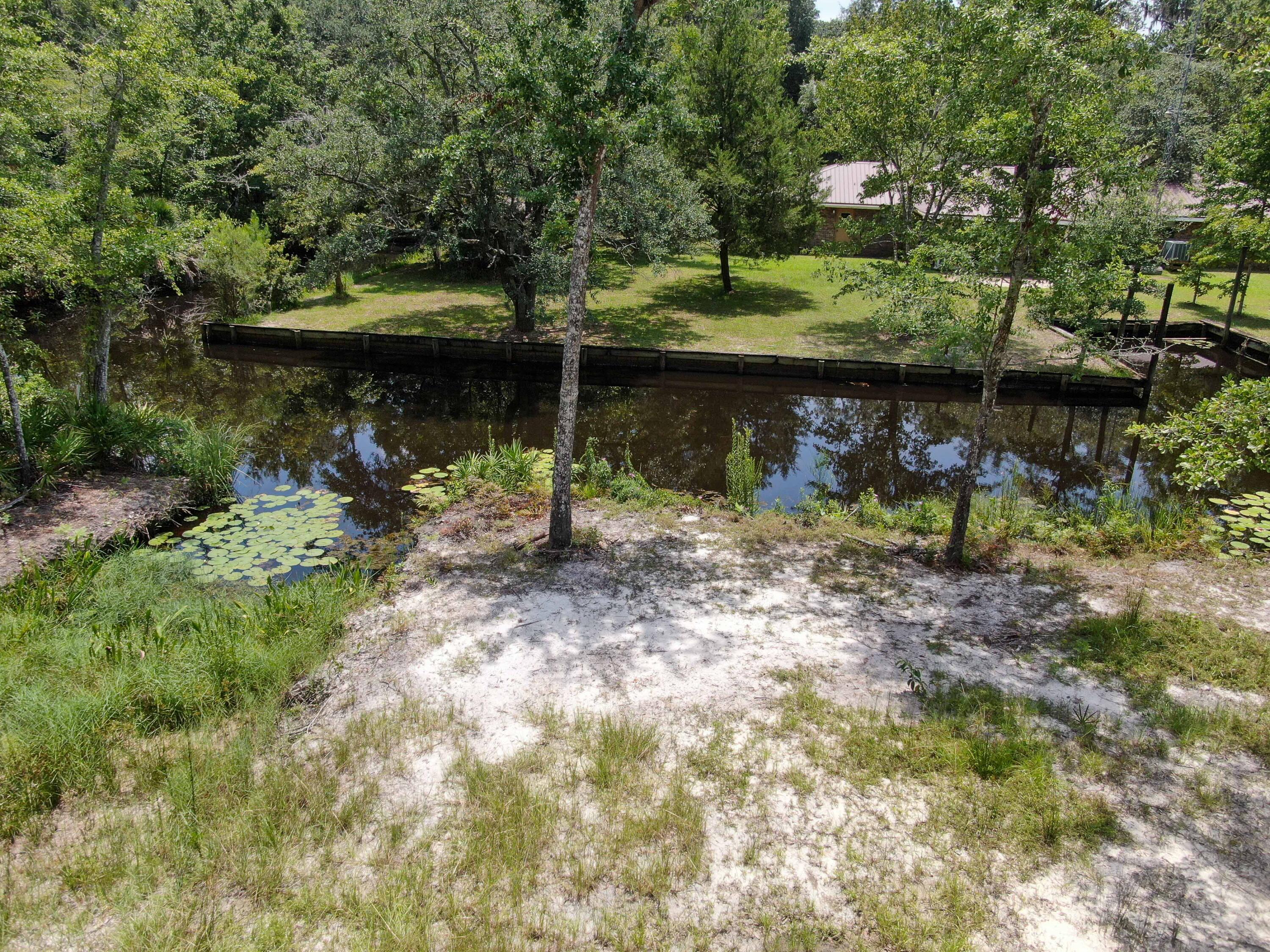 Build your new canal front lot that leads into the Choctawhatchee Bay! Seller has already paid for the city water & sewer tap and they are both located on the property. Seller has also brought in a few loads of fill dirt that is stacked on the property, saving you some money! This beautiful waterfront lot has been partially cleared. Just a few minute boat ride from this lot and you are in the Choctawhatchee Bay for a day of fishing, water sports or a ride into Destin. These lots on Wilson Way don't come available very often so scoop it up today!