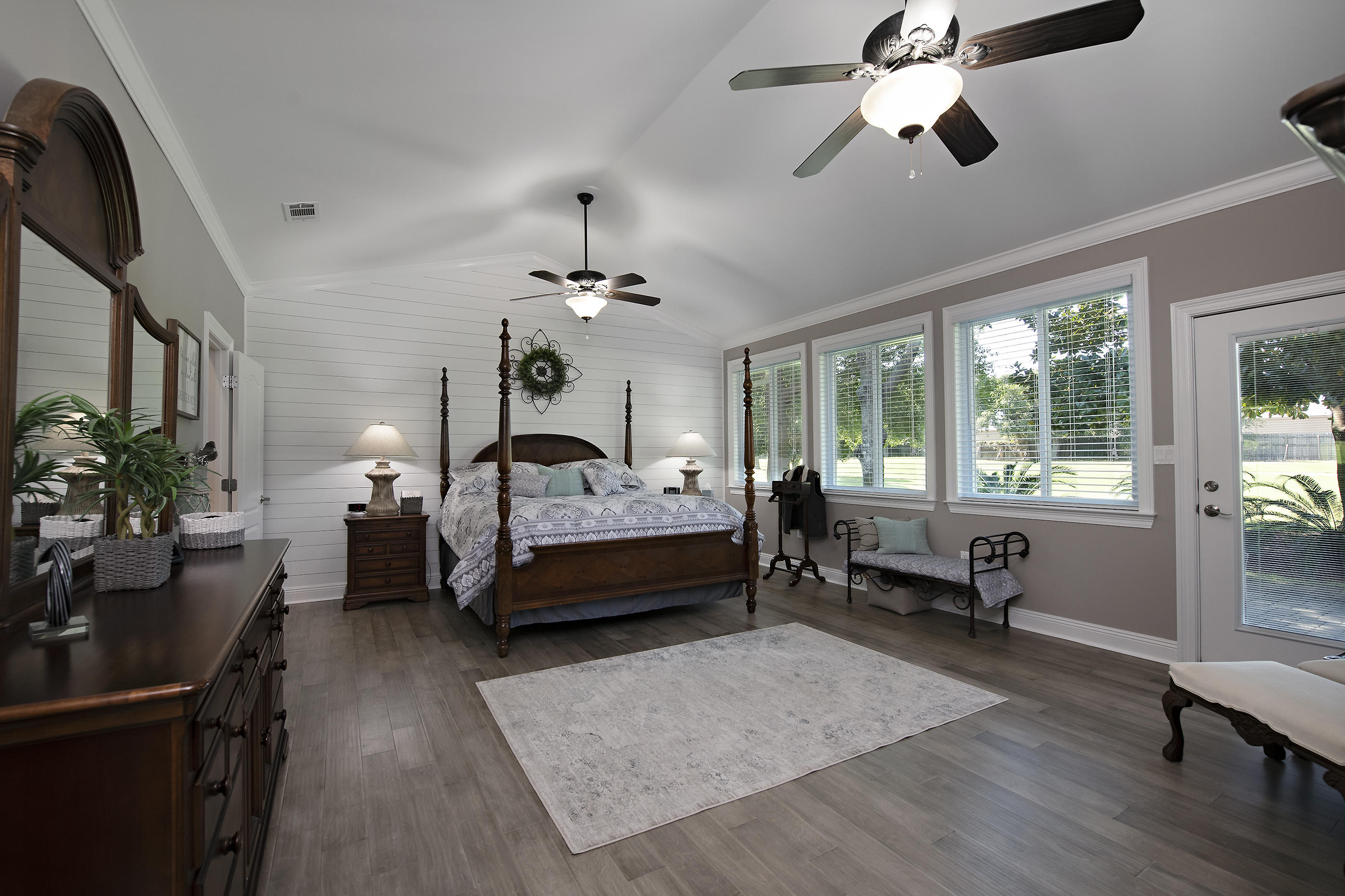 the entire home has 9 foot or volume ceilings and extensive crown molding and chair rail. There is ceramic tile flooring in most areas and engineered hardwood in the master. The lodge style great room features a tongue and grooved wooden ceiling and fireplace with gas logs. The master bedroom has new paint, hardwood flooring, a shiplap feature wall and new blinds. Windows were replaced with Andersen Low-E ones that let natural light in, assist in lowered electric bills, and also help stop fading of fabrics and woods that can occur with regular glass. The kitchen has 42'' custom cabinets with tons of storage, quartz countertops, tiled backsplash, stainless steel appliances, center island with cooktop, downdraft vent, and overheard lighted pot rack. Ge Monogram Standalone ice maker. Two pavered driveways, 3 car garage, intercom system, large rear patio, and many windows to see the beautiful landscaping and golf course. Walk in closets in all bedrooms, ten ceiling fans.  2 hot water heaters, 2 heat pumps that divide the home in 2 zones for accurate heating and cooling.  Tucked away in a quiet neighborhood from most of the resort, yet just a short golf cart ride to Baytowne Village & Marina, the beach, 4 golf courses, New Vision Theater, Publix, the bay, fitness centers, resort pools and dining & shopping at Grand Boulevard.  This home must be seen to be appreciated.