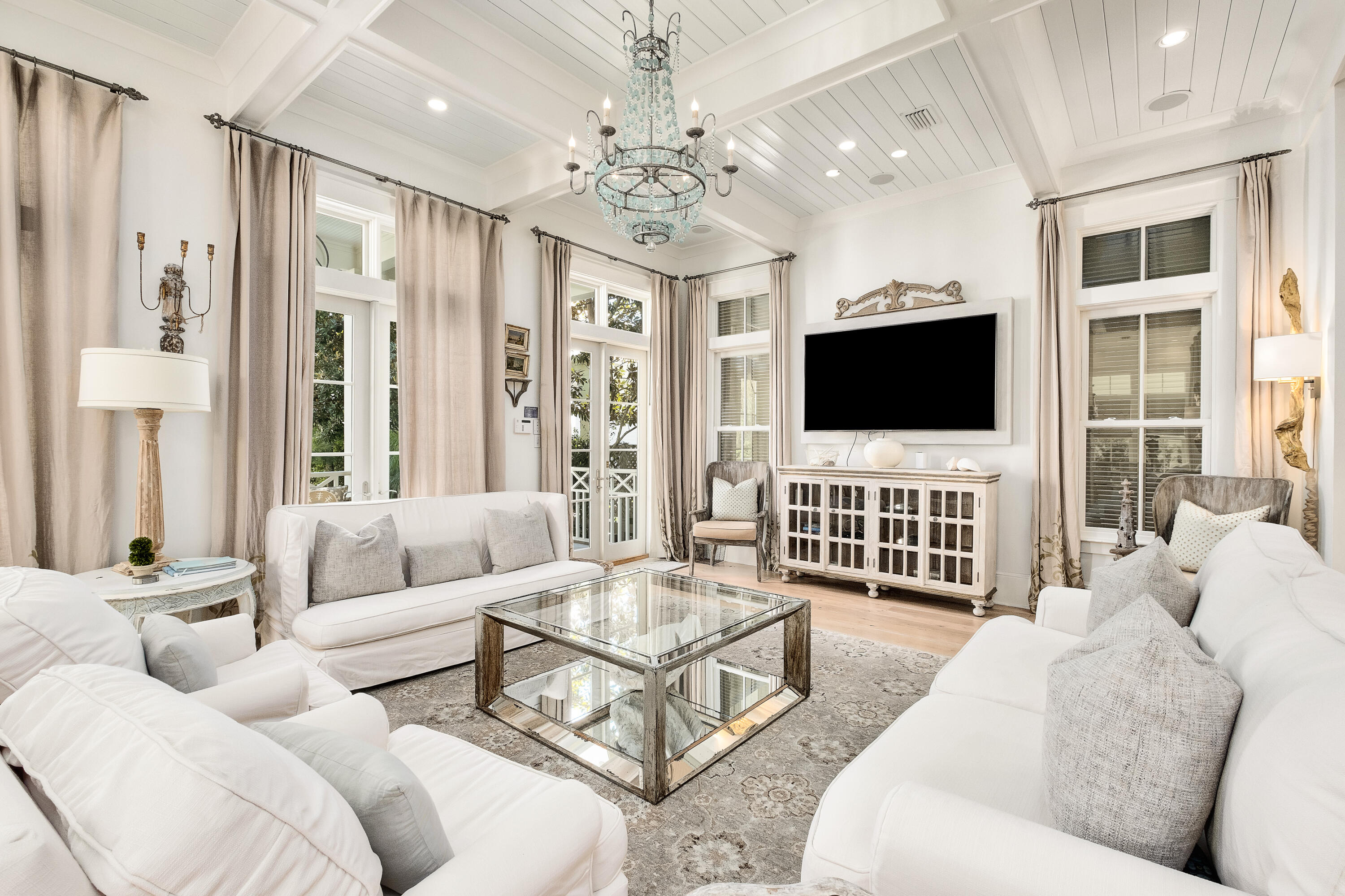 Welcome to 73 Western Lake Drive where coastal luxury meets unrivaled sophistication. Primely located in Phase I of Watercolor along Scenic Highway 30A, this meticulously crafted and designed home boasts 5 bedrooms & 6 baths, including a detached carriage house with a fully equipped kitchen. Every detail of this home exudes opulence and refinement making it a true masterpiece in its own right.

Prepare to be captivated as you step into the heart of this residence— reclaimed white oak flooring leads into the expansive open kitchen, designed by Le Gardes of New Orleans, a true culinary haven. Venetian marble countertops and custom cherry cabinets are highlighted by 12' shiplapped ceilings. The kitchen is equipped with top-of-the-line Wolf, Miele, and Subzero appliances. A convenient butler's pantry and dedicated wine cooler makes entertaining guests effortless and enjoyable.

The living room features a semi-private dining area and an abundance of windows that invite the gentle coastal breeze and warm natural light. The room is tied together by a double-sided marble fireplace centerpiece that adds an air of sophistication to the space. Floor-to-ceiling French doors leading out from the living room to the private heated pool create an idyllic and dynamic entertainment space. With over 2,500 square feet of covered porch space trimmed out in impeccable ipe cypress, this residence seamlessly merges indoor and outdoor living, allowing you to be fully immersed in the tranquility of a private oasis while still being in the heart of Watercolor. 

The reclaimed white oak flooring gracefully guides you through the residence, infusing rustic charm and timeless character at every step. The soaring coffered ceilings create an ambiance of grandeur, evoking a sense of awe and admiration. The second floor provides a more private retreat and boasts the generously sized owner's suite. The owner's primary suite is a spacious 20x20 masterpiece that has its own private deck, walk-in closet, and ensuite bathroom with a walk-in shower and freestanding bathtub. Three guest bedroom suites also occupy the second floor, each meticulously appointed to offer the utmost in luxury living. Two of these suites present a unique arrangement of queen-over-queen bunk beds, providing a playful yet elegant space for family and guests. One of the most unique features of the home is a secret passage door behind the bookcase that leads to a spiral staircase, unveiling a third-floor tower room, where you can immerse yourself in panoramic sunset vistas and views of the Gulf of Mexico as you relax in ample seating.

Nestled above the oversized, two-car garage is a private carriage house that exudes both comfort and functionality. This separate living space offers a retreat of its own, complete with a full kitchen, a generously sized bedroom capable of accommodating a king-size bed, a private bath, and its own living room that comfortably seats six. The kitchen boasts a convection microwave, induction cooktop, and beverage cooler. 

One of the most iconic communities along Florida's idyllic 30A, WaterColor has a state-of-the-art waterfront beach club and a plethora of activities to entertain beachgoers of all ages. Additional amenities include Camp Watercolor, multiple parks and walking/running trails, the boathouse for paddleboard and kayak rentals, and multiple community pool and sporting options. Tucked between Seaside and Grayton.